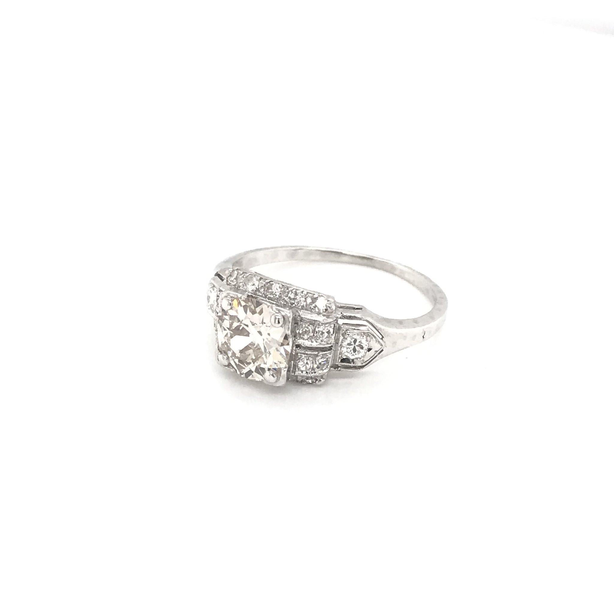 This beautiful antique piece was handcrafted sometime during the Art Deco design period ( 1920-1940 ). The platinum setting features a sparkling center diamond that measures approximately 1.10 carats. The center diamond is an Old European cut and