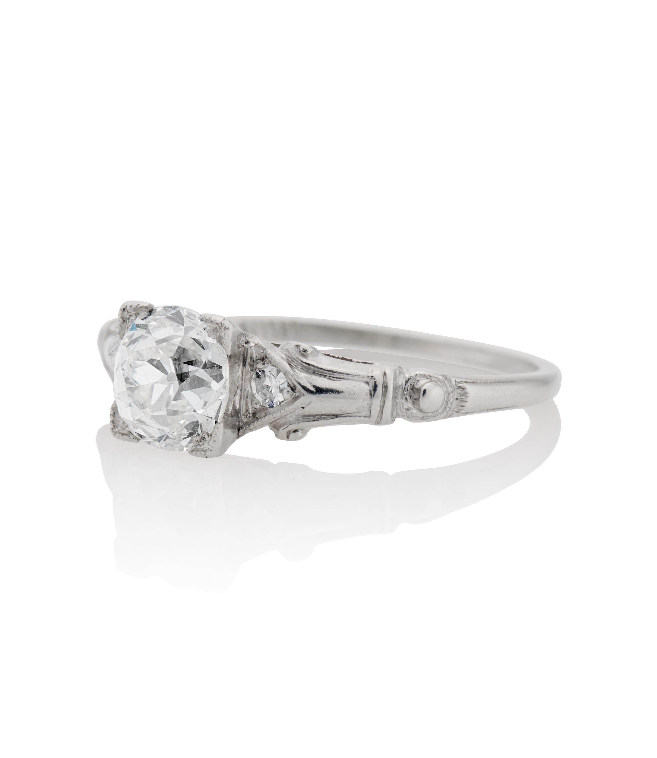 Description 
Antique Art Deco engagement ring centered with a 1.10 carat Old European Cut diamond and 0.50 carats of diamond accents within a platinum setting with hand engraving and geometric designs. A unique style from the Art Deco era as well as