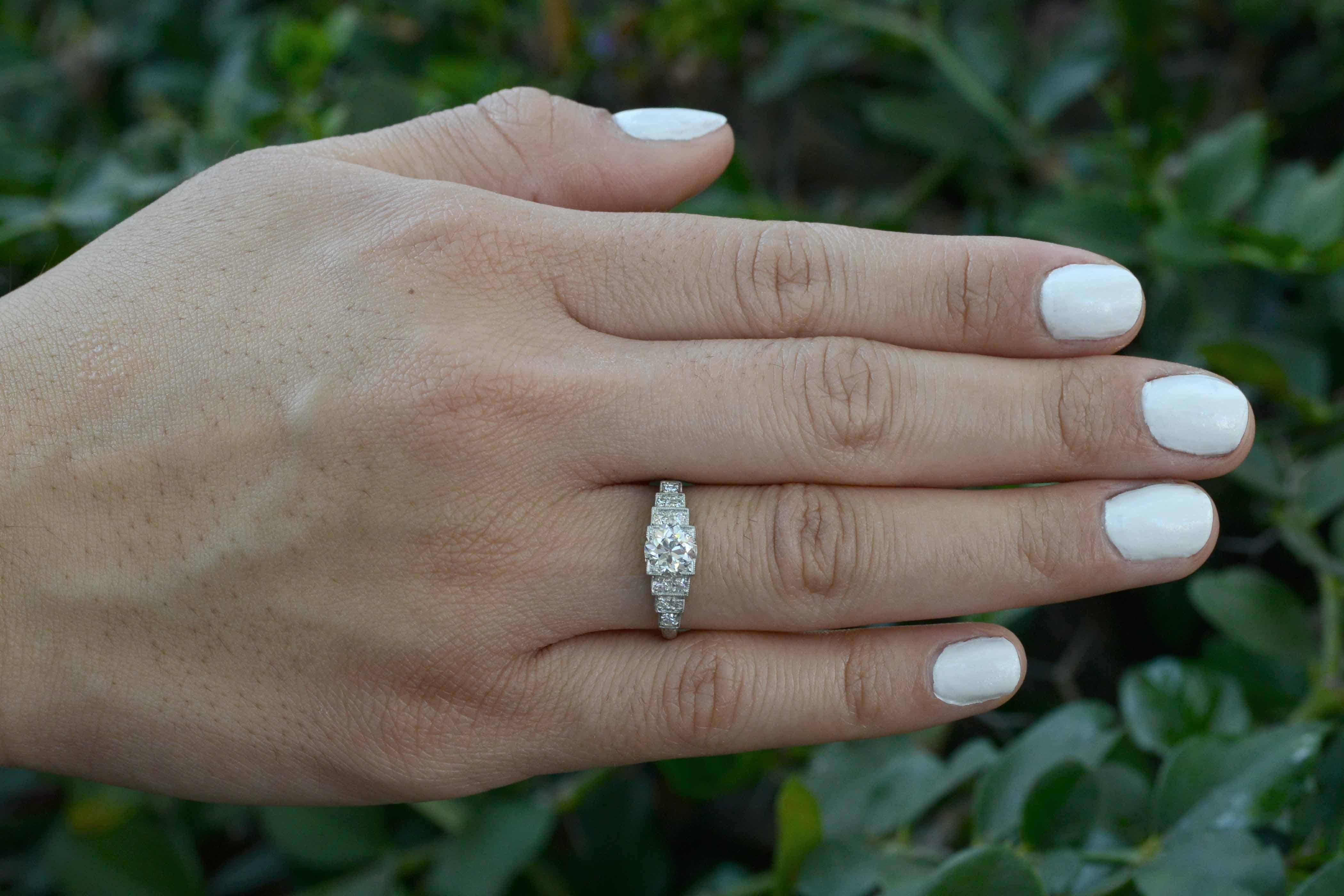 So much drama in this authentic, period Art Deco engagement ring. The tiered, staircase design is centered by a glimmering, fiery and bright Old European diamond of almost one carat (0.95cts) accented with a tiered staircase of diamonds outlined