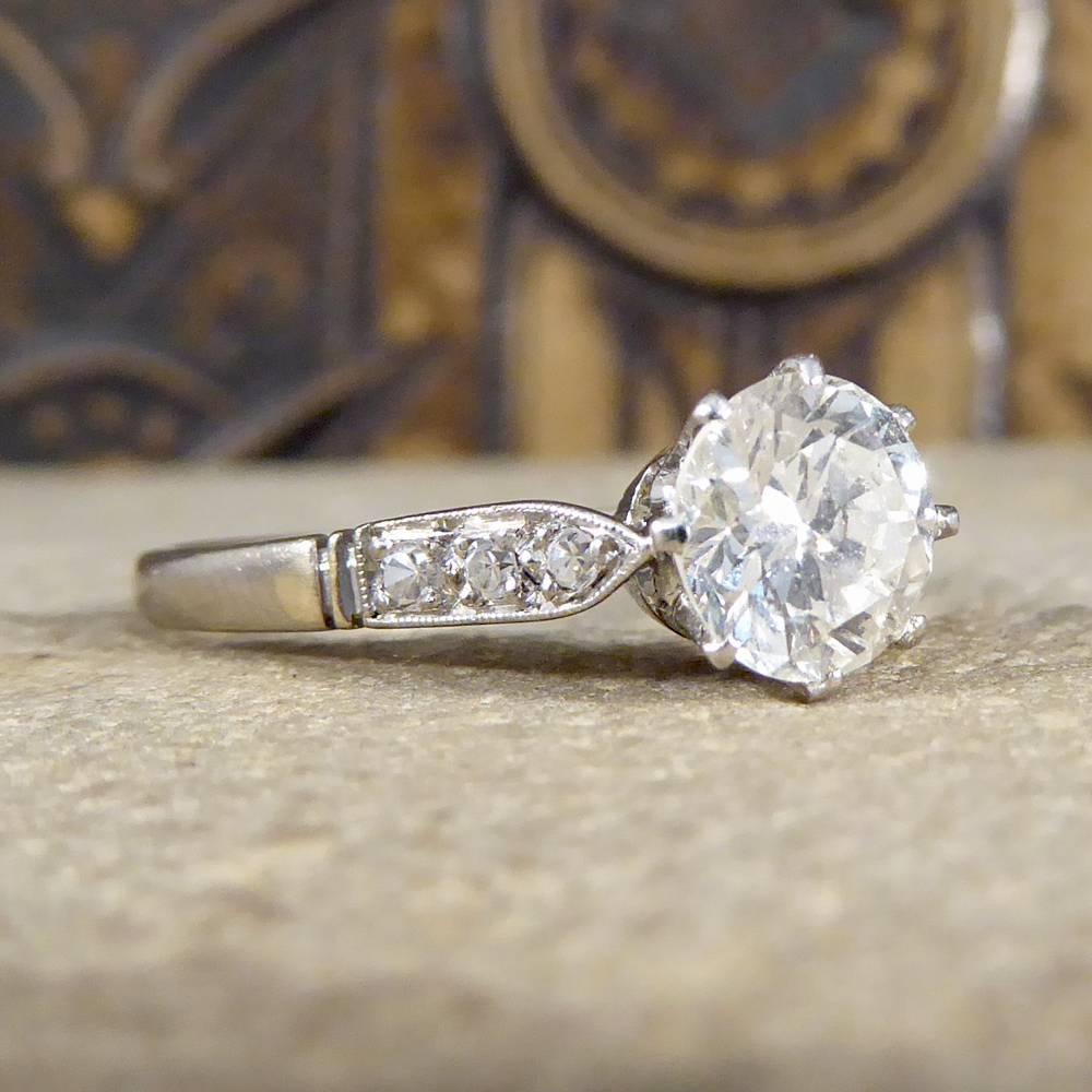 This beautiful and impressive Art Deco engagement ring has been crafted in 18ct White Gold. The 1.10ct round brilliant cut Diamond is sat in a pierced decorative, basket style setting, with eight claws holding it securely in place. Accompanying this