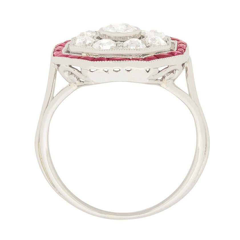 This fabulous art deco target ring features old cut diamonds encircled by a ring of french cut rubies. The centre diamond is 0.30 carat, while the surrounding eight diamonds are 0.10 carat each. The diamonds all match for quality, with grades of G