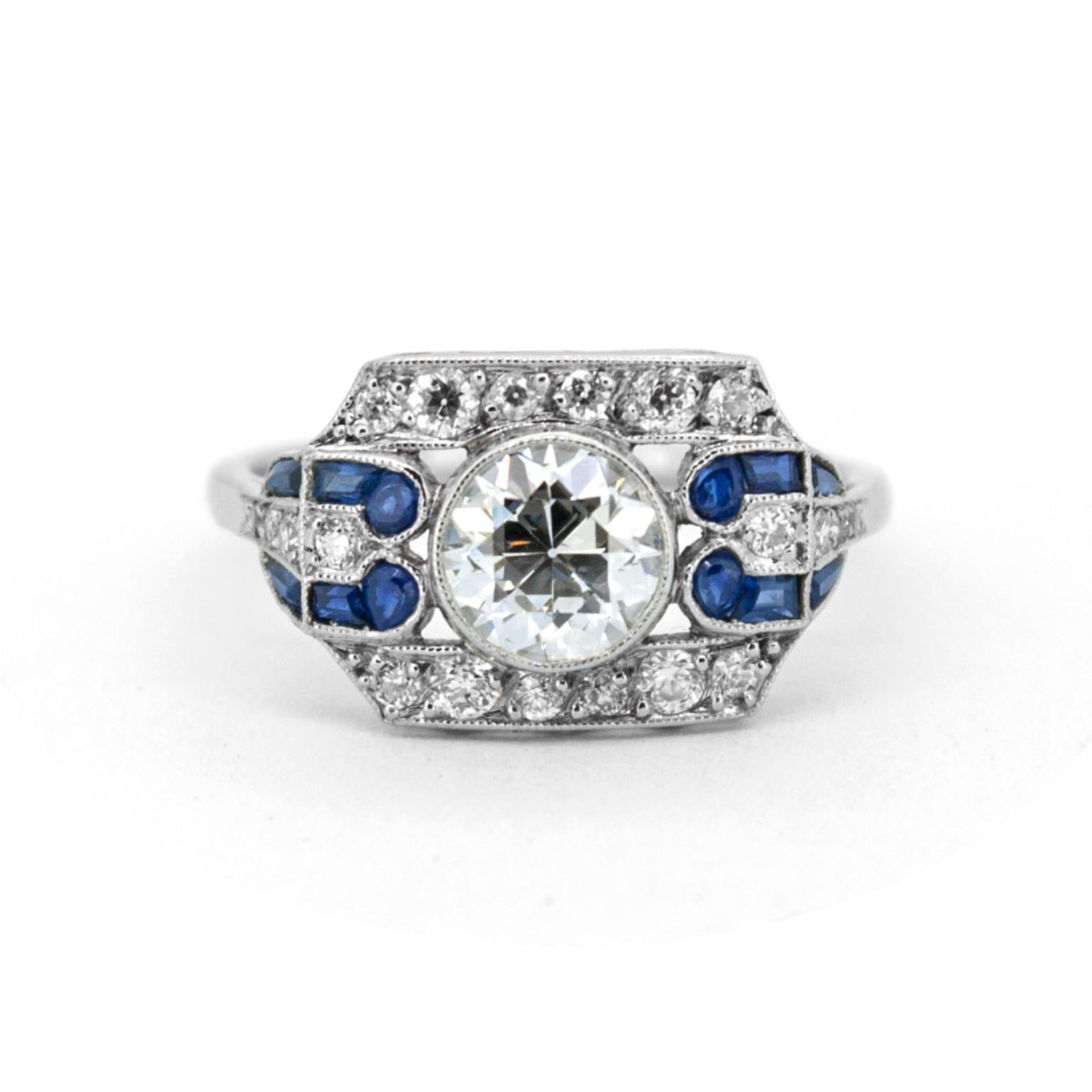 Rarely do we find an original Art Deco ring with the quality and detail exhibited in Henrietta; from the exceptional transitional cut diamond, aglow with fire and brilliance, to the vibrant sapphires, which were precision cut just for this