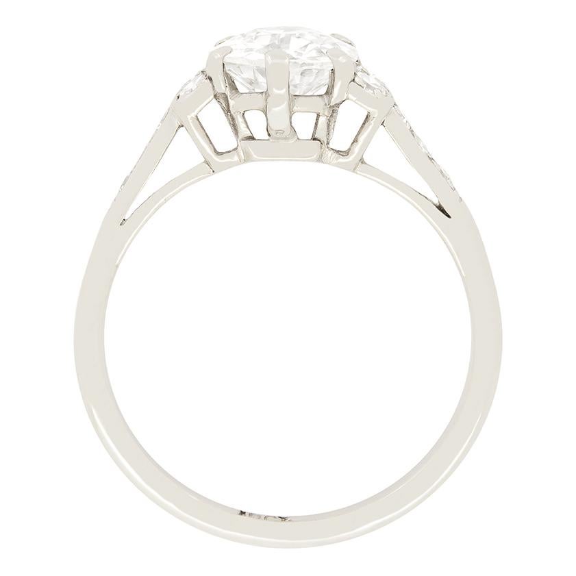 Dating back to the wonderful Art Deco era is this gorgeous solitaire engagement ring. Set within six claws is an old cut diamond weighing 1.15 carat. It has been graded as G in colour and VS2 in clarity. Directly set to either side of the central