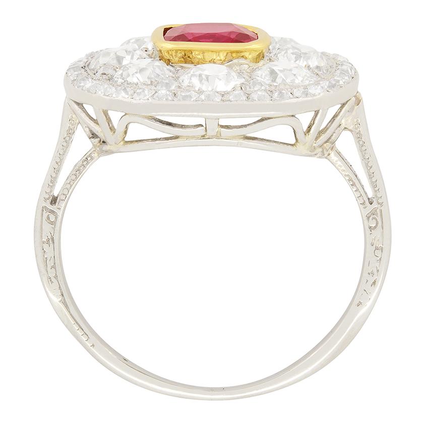 This Art Deco show stopper features a wonderful red ruby in its centre with multiple diamond halos surrounding the stone. The central ruby is and old cushion cut, 1.15 carat stone and is rub over set into 18 carat yellow gold. The first halo