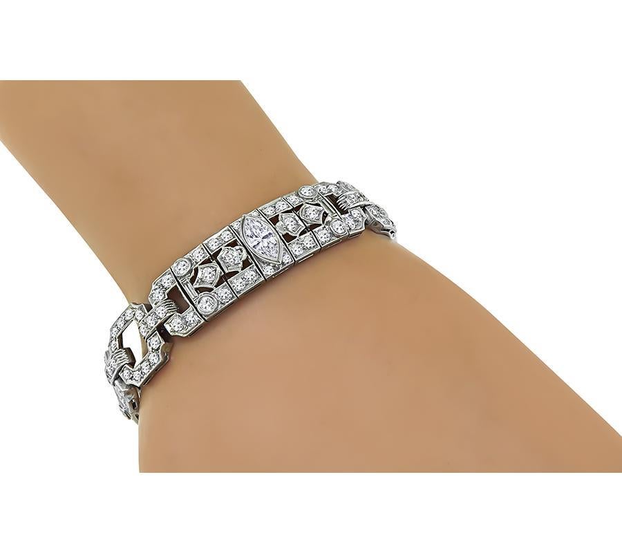 This is a stunning platinum bracelet from the Art Deco era. The bracelet is set with sparkling baguette, round, marquise and old mine cut diamonds that weigh approximately 11.75ct. The color of these diamonds is G-H with VS clarity. The bracelet