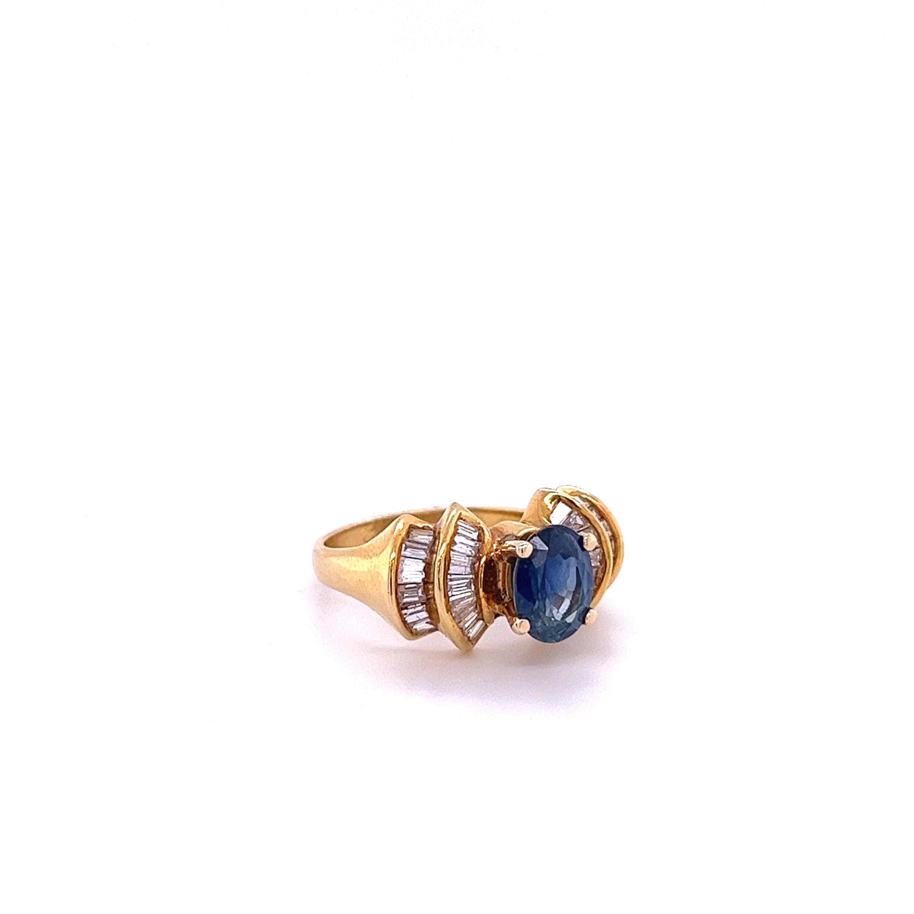 1.19-carat oval cut Blue Sapphire set with 0.66 carats in baguette-cut diamond accents in a 14k yellow gold ring. A stunning Art Deco-themed ring with symmetrically patterned baguette diamonds. 

Polished finish for a long-lasting shine. Waterproof,