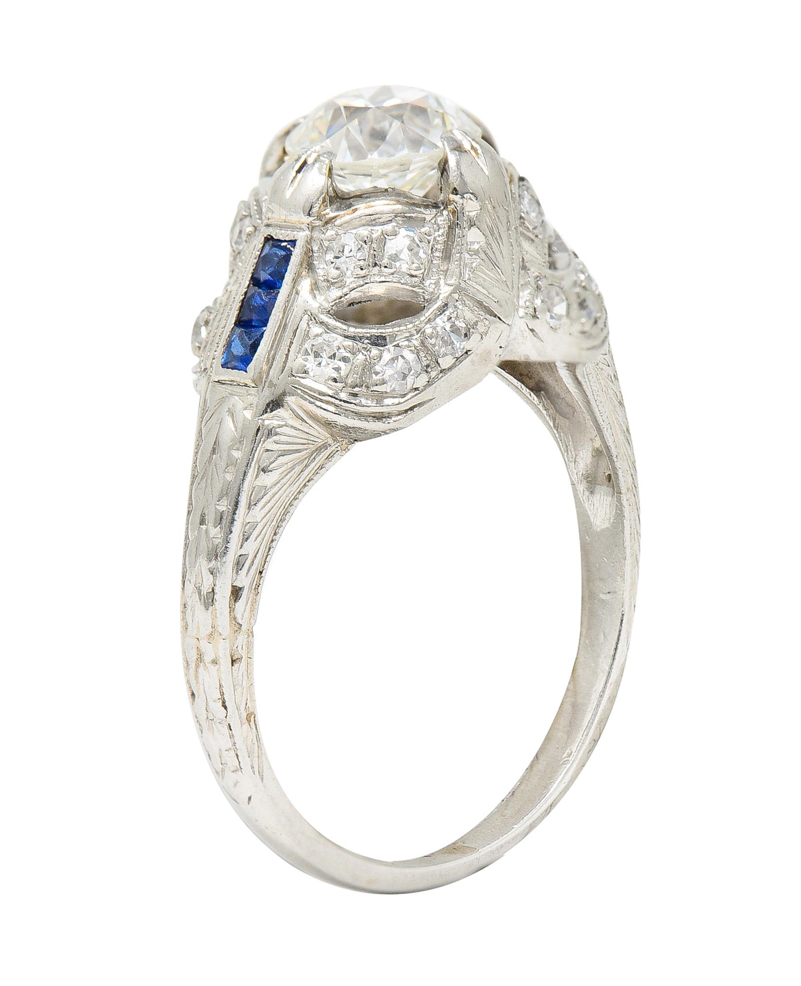 Centering an old European cut diamond weighing approximately 0.83 carat total - I color with VS clarity. Set with split prongs featuring a pieced scrolling ribbon motif surround with bead set single cut diamonds. Weighing approximately 0.20 carat