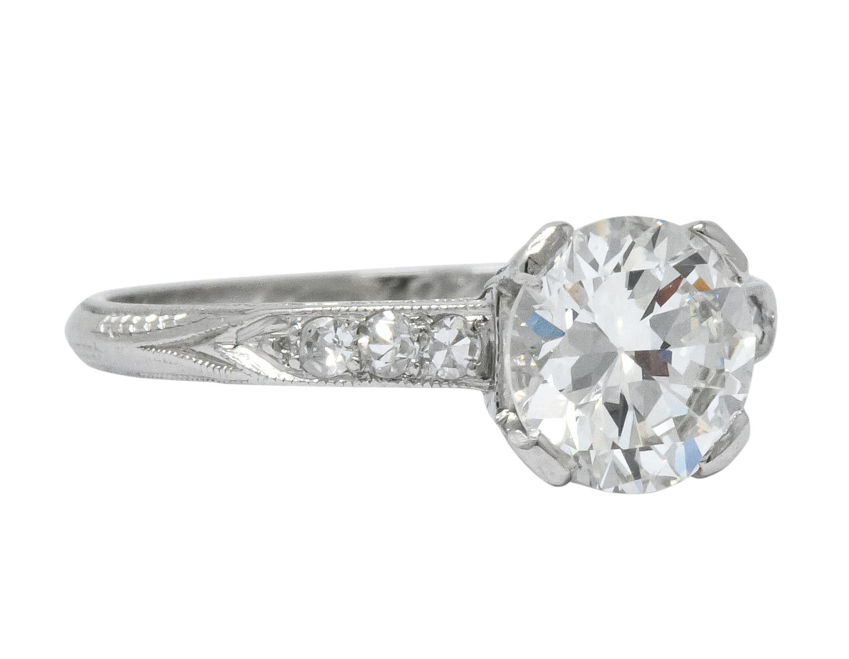 Centering a transitional cut diamond weighing 1.08 carat, H color and VVS1 clarity

Flanked by single cut diamonds, six total, weighing approximately 0.12 carat total, G color and VS clarity

In a four 'ribbon' style prong setting, with millegrain