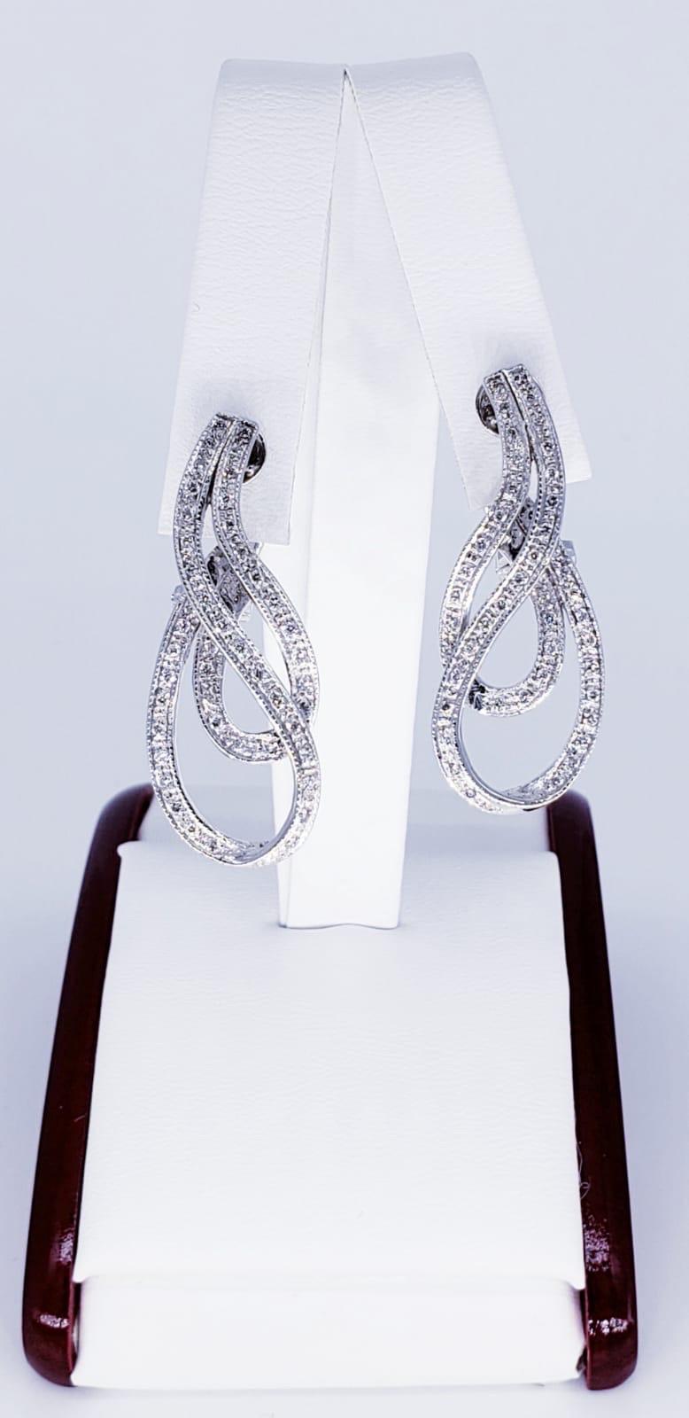 Art Deco 1.20 Carats Diamond Earrings. The earrings have a beautiful design swiveling around making it stand out with the bright diamonds approximately weighing in total 1.20 carats. The earrings are crafted in 18 karat solid gold & weight 13.5