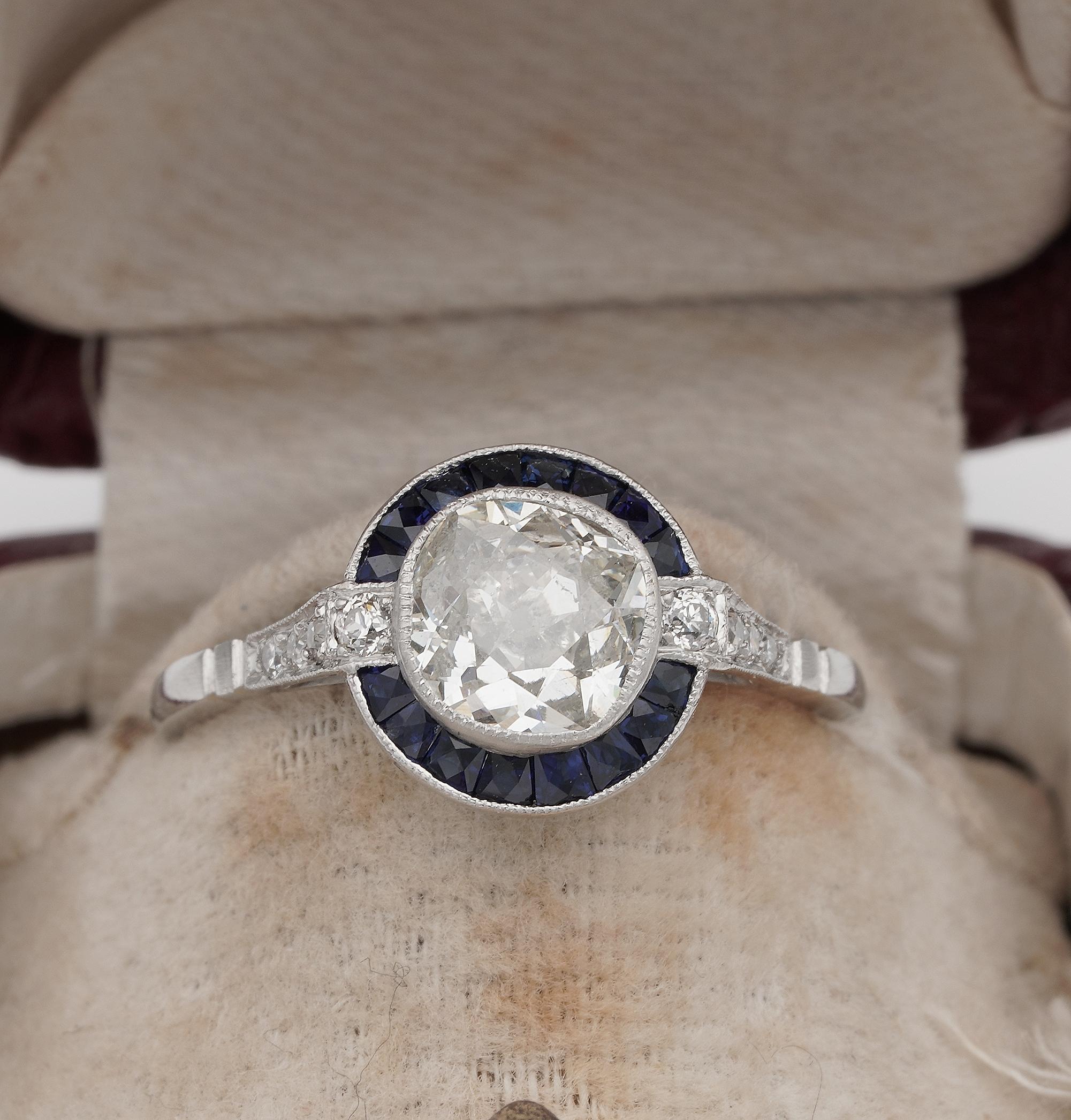 Desirable!
Art Deco style beautiful designed target ring set with old mine cut solitaire Diamond with a halo of square cut natural Sapphires and gorgeous Diamond shoulders
1920 ca, hand crafted of solid Platinum, marked
Centrally set with an old