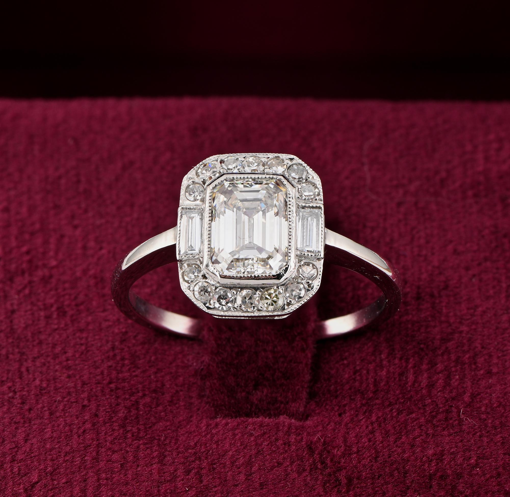 Diamond Allure
This superb Art Deco period Diamond solitaire ring is 1925 ca.
Hand crafted of solid Platinum in a timeless stunning design taking the shape from the centre Emerald cut Diamond with a surrounding border of baguette cut on sides and
