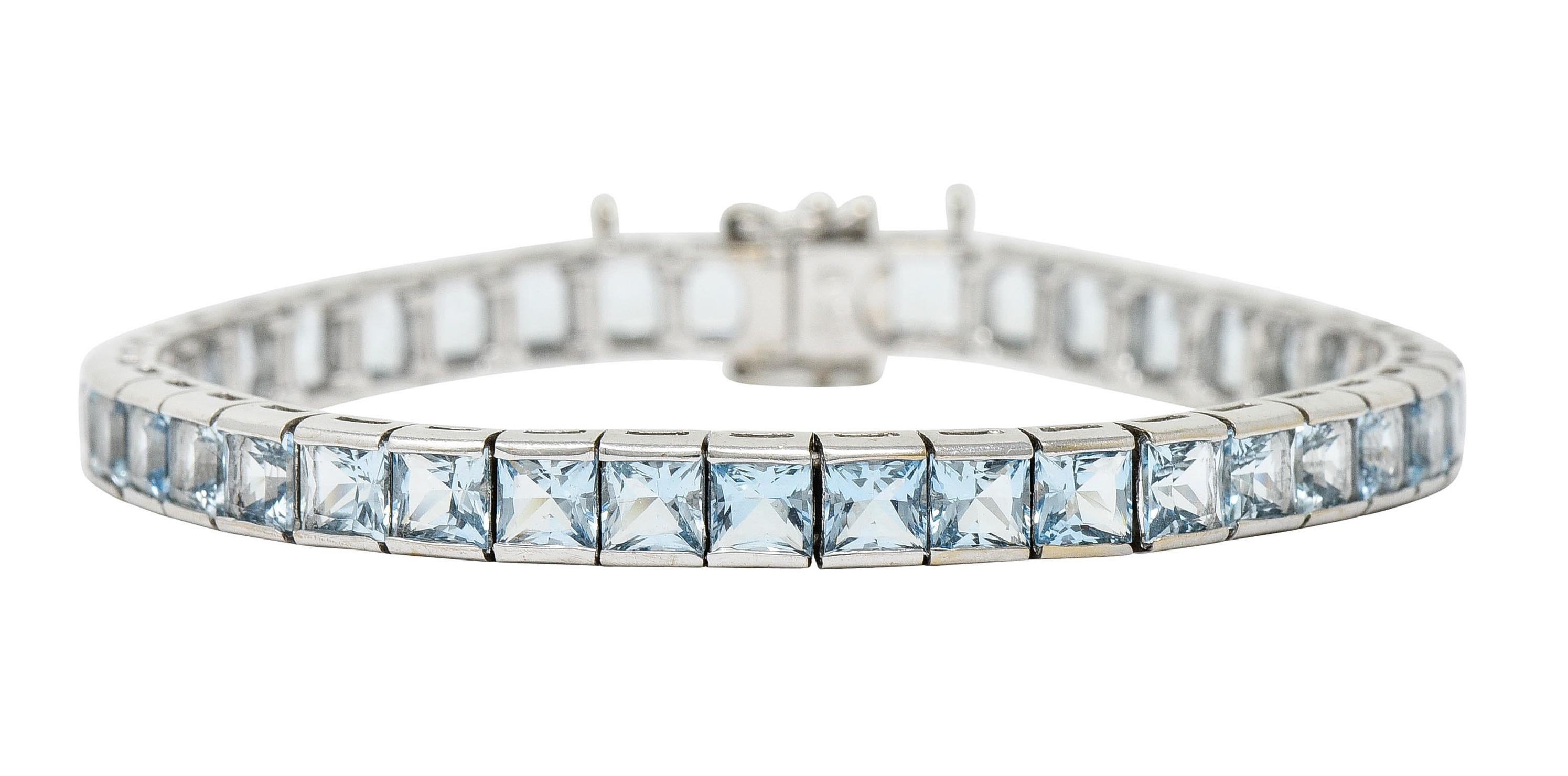 Line bracelet is comprised of square form links

Each set with square cut aquamarine weighing in total approximately 12.00 carats

Very well matched, transparent, and medium light greenish blue in color

Completed by a concealed clasp and two figure