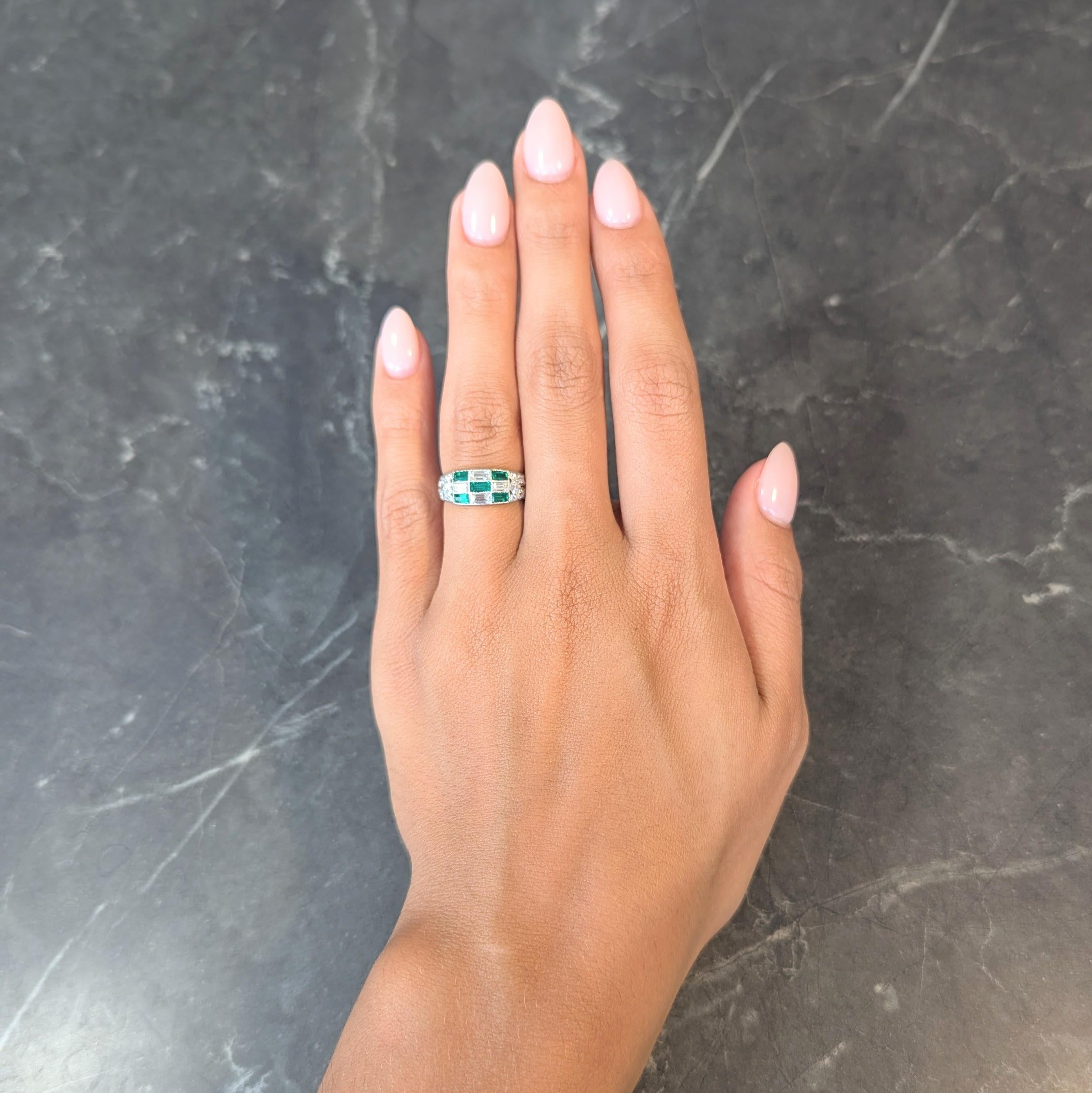 Centering three rows of baguette cut diamonds and emeralds bezel set as checkerboard pattern
Diamonds weigh approximately 0.54 carat total - G/H color with VS2 clarity
Emeralds weigh approximately 0.40 carat total - transparent medium green 
Flanked