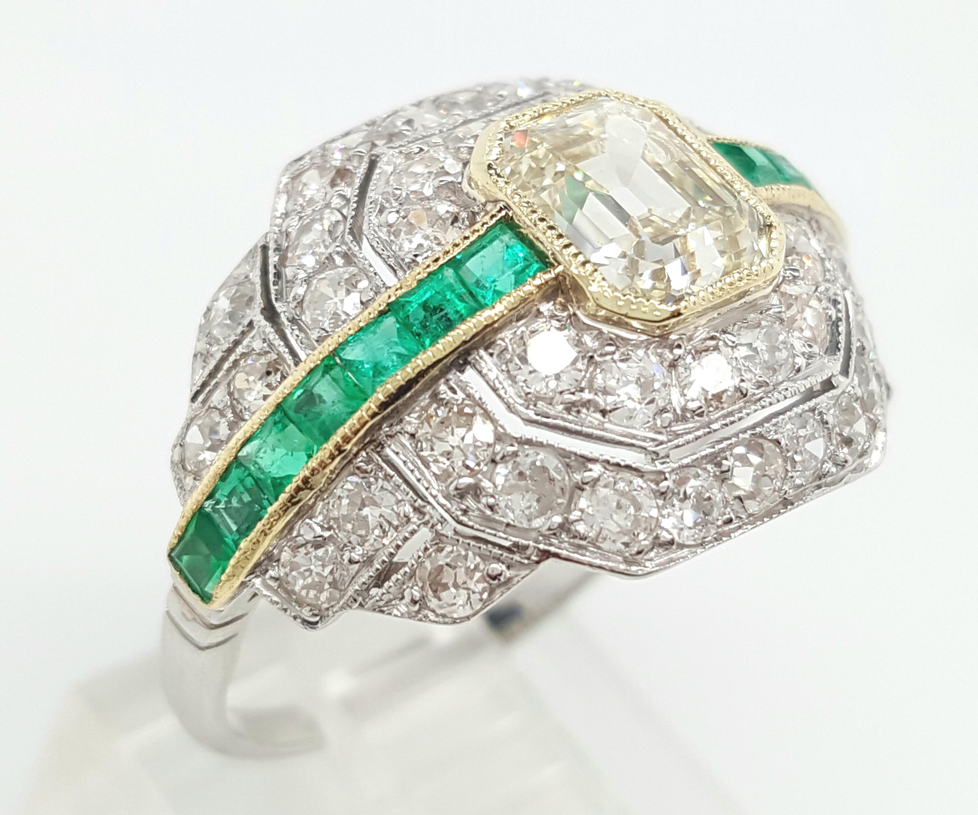 This fine Art Deco ring is a true treasure kept in excellent condition. The ring is an example of pure excellance and its unique design is one of a kind. The center is a stunning 1.24 carat emerald cut diamond and it is bezel set with a delicate