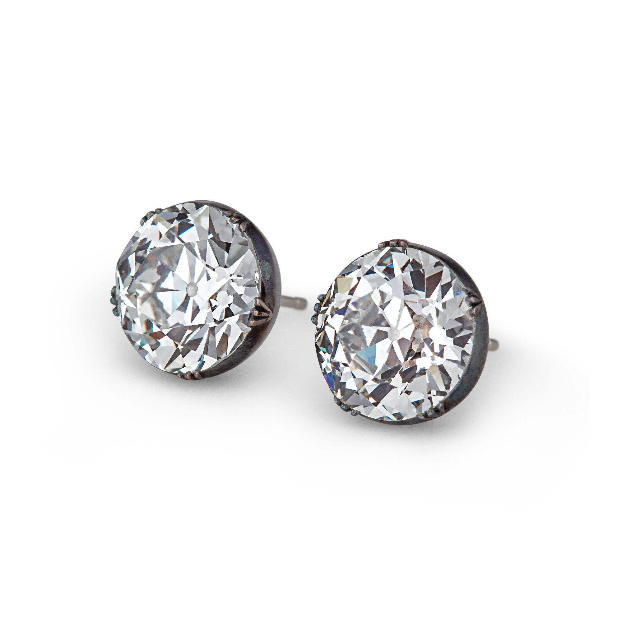 Light yourself up with these fiery and fun oversized Art Deco Old European cut diamond studs weighing a total of 12.42 carats.   Set elegantly in an antiqued silver, 18 karat rose gold, and platinum collet mounting, these one-of-a-kind earrings are