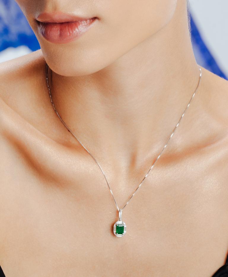Art Deco Emerald Diamond Halo Pendant in 18K Gold studded with octagon cut emerald. This stunning piece of jewelry instantly elevates a casual look or dressy outfit. 
Emerald enhances intellectual capacity of the person. 
Designed with octagon cut