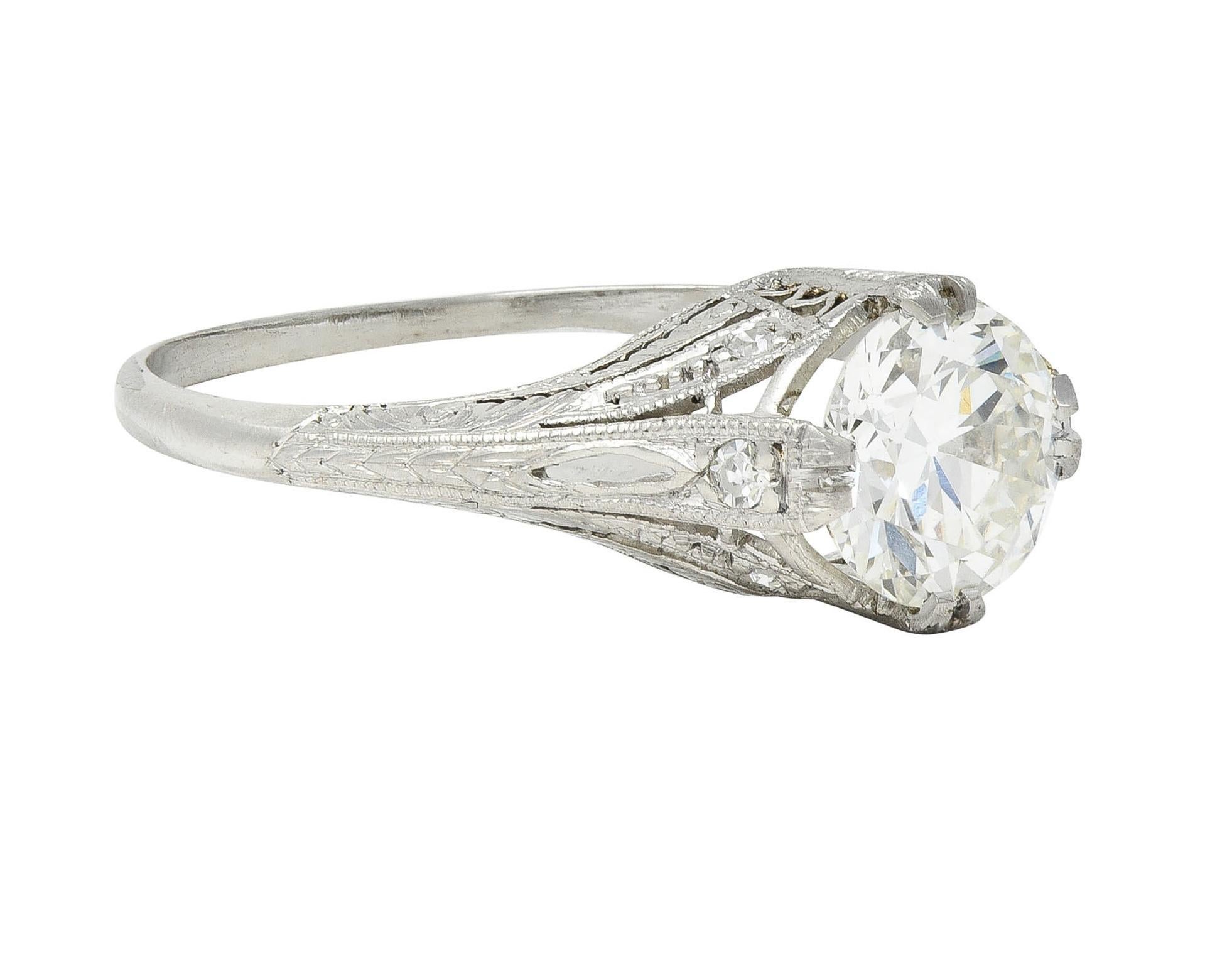 Centering an old European cut diamond weighing approximately 1.18 carats - J color with VS2 clarity
Set by stylized split prongs engraved with a wheat motif
Accented by single cut diamonds weighing approximately 0.08 carat total - eye clean and