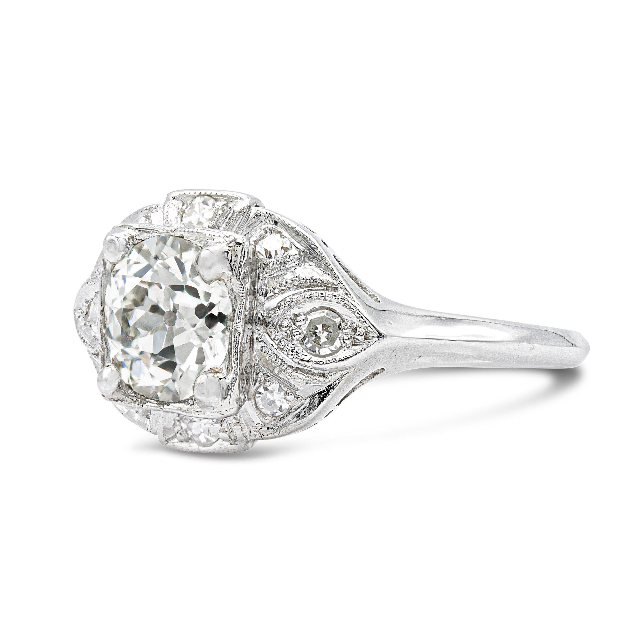 One of the most intriguing deco-era engagement rings styles are framed settings. Boasting romantic metalwork studded with small single cut diamonds, it sits elegant low across the finger. An attractive old Euro, 1.30 carats, with mesmerizing facets