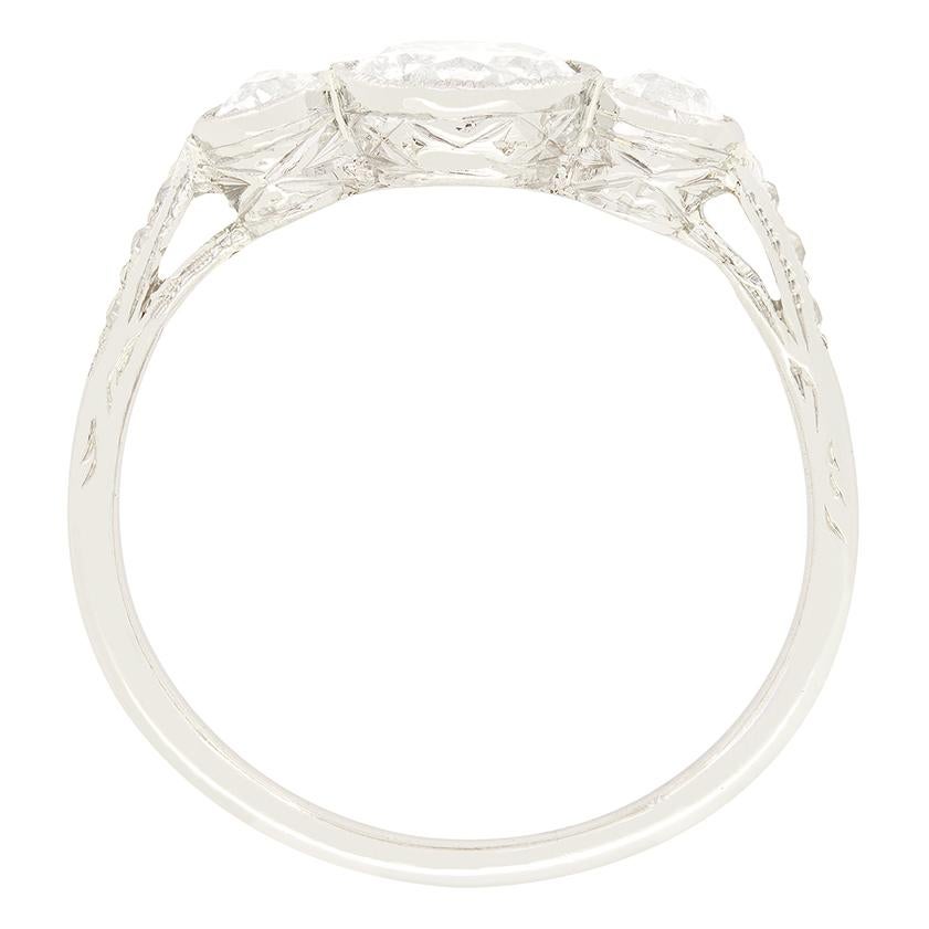 This classic trilogy ring was made by hand in the 1920s. A beautiful 0.90 carat old cut diamond sits central with two 0.20 carat stones sat either side. The rub over set diamonds range in colour from G to H and match in clarity at VS2. Crafted