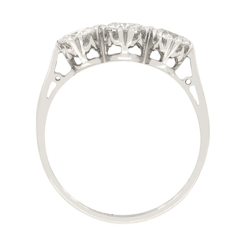 This classic trilogy ring was crafted in the 1920s at the height of the Art Deco period and features three old cut diamonds. The middle diamond is the largest at 0.50 carat, whilst the flanking pair are 0.40 carat each. All three diamonds match in