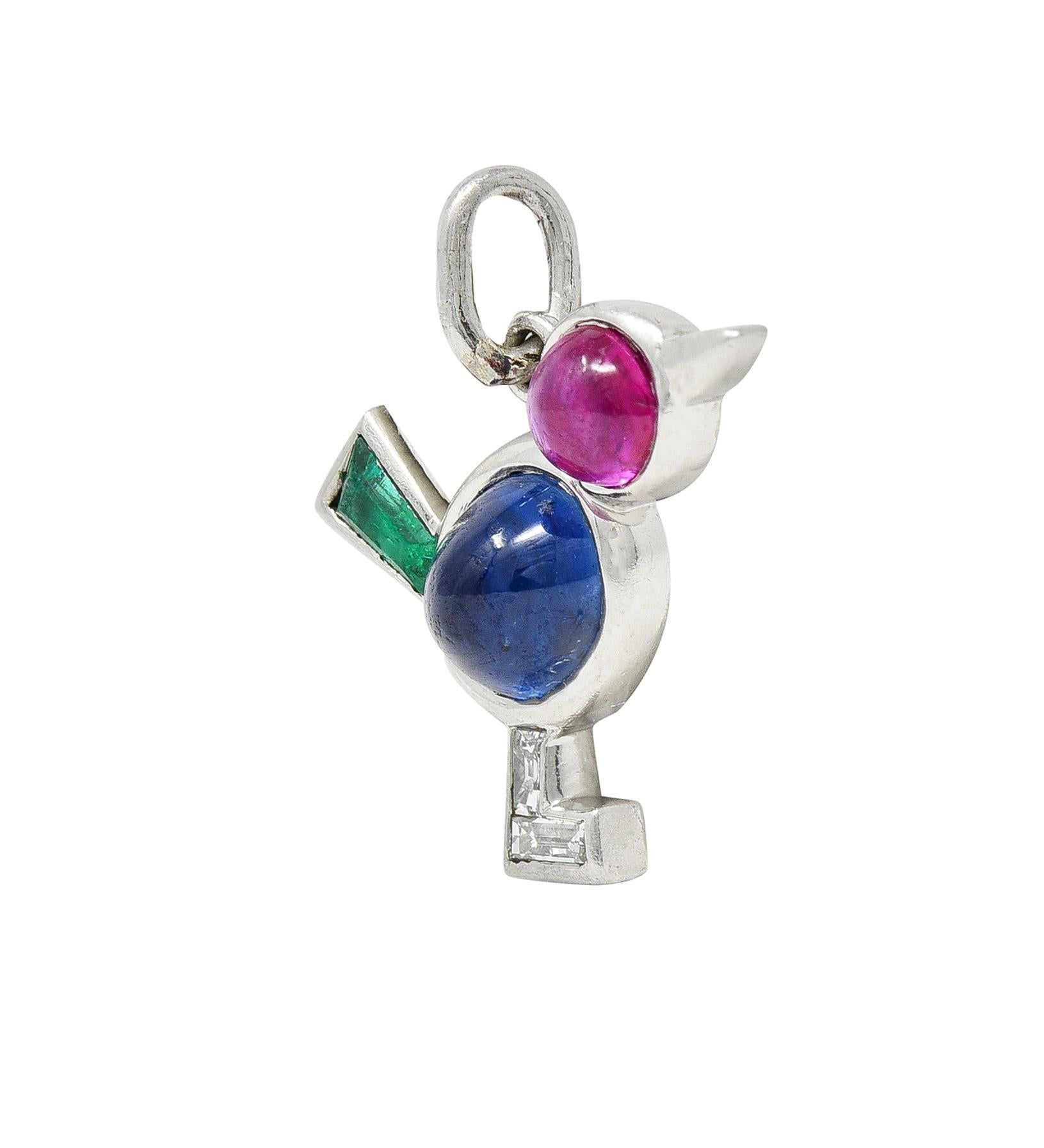 Designed as a stylized bird comprised of bezel set gemstone features
Centering an oval-shaped sapphire cabochon body 
Weighing approximately 0.86 carat - transparent medium blue
Accented by a round-shaped ruby cabochon head 
Weighing approximately