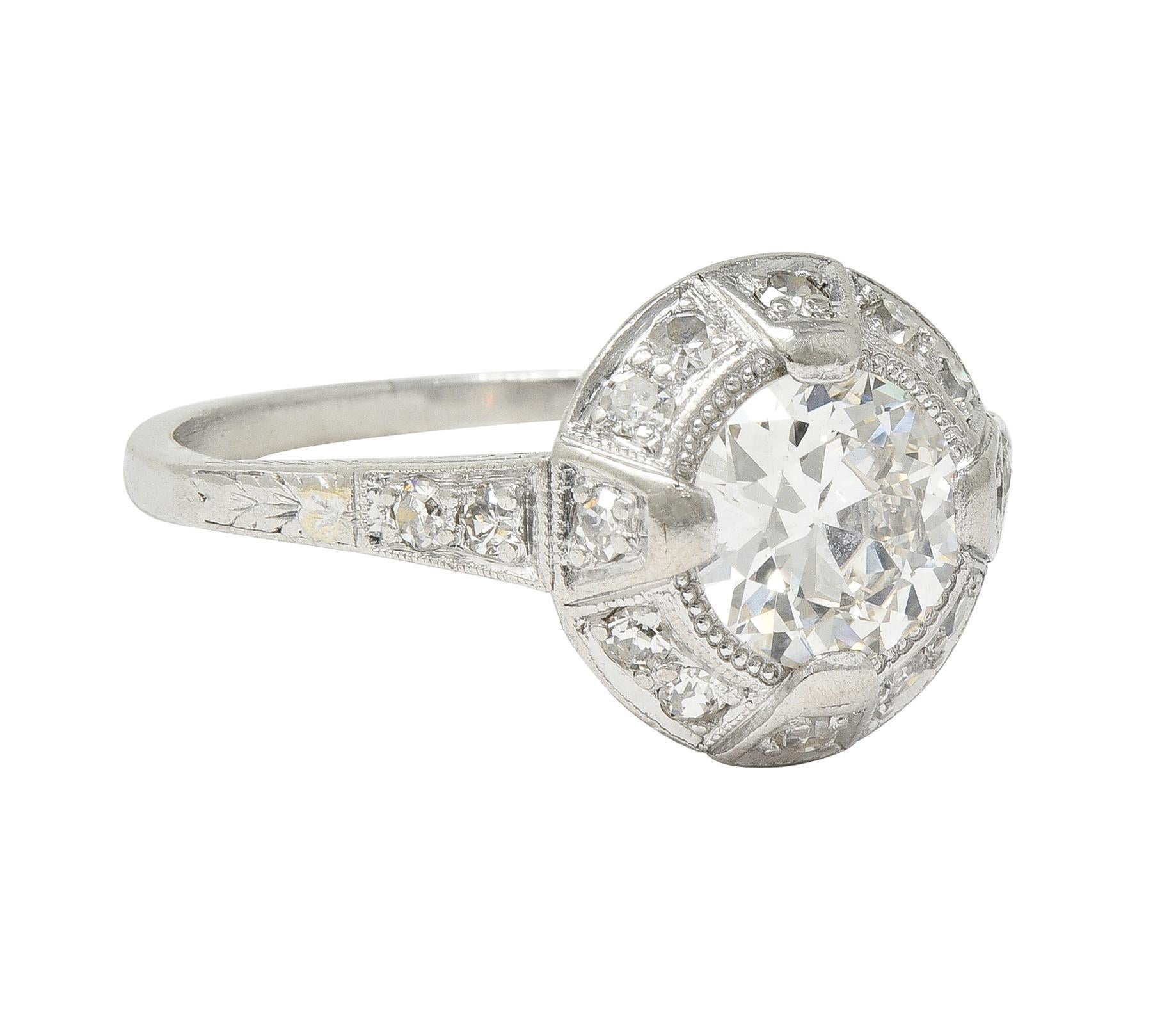 Centering an old European cut diamond weighing approximately 0.90 carat -G color with VS1 clarity
Set with wide tab-like prongs with a recessed halo surround bead set with single cut diamonds 
Weighing approximately 0.42 carat total - eye clean and