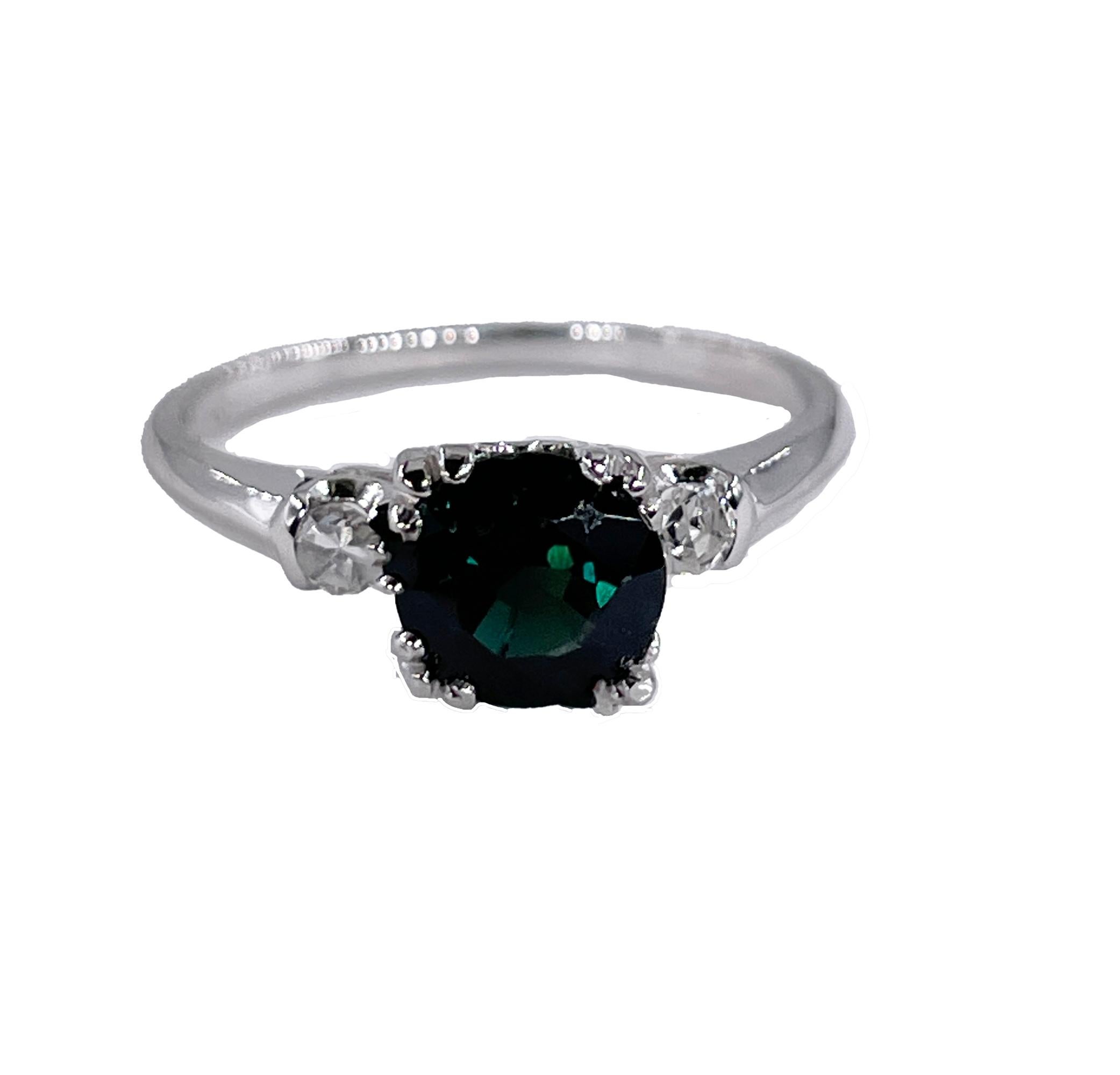 Offered for sale is a truly superb vintage Art Deco era ring (circa 1930s) crafted beautifully in 18k white gold. This striking and sparkling Jewel is adorned with exceptionally rare color sapphire - GREEN . The enduring and alluring Sapphire forms