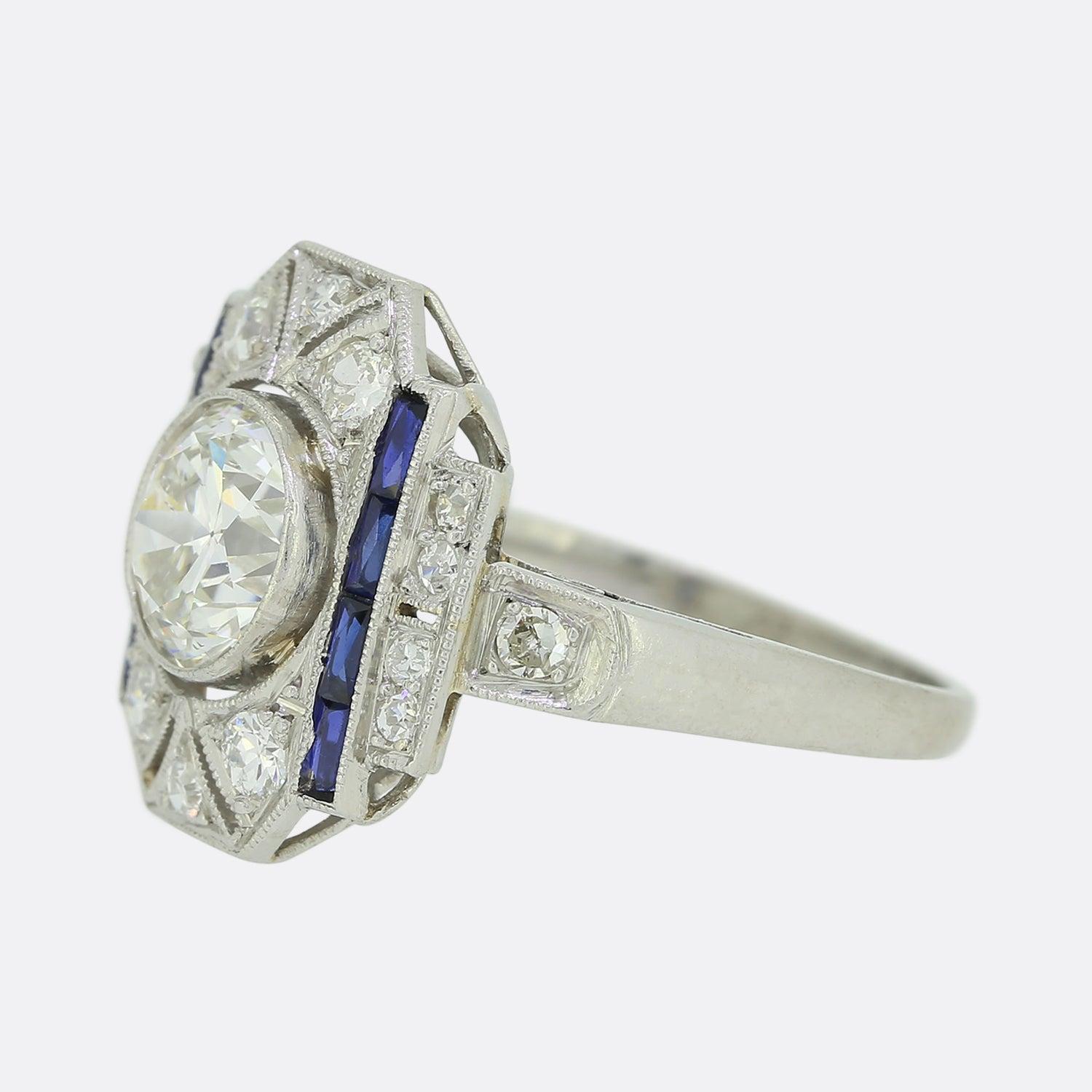 Here we have an original Art Deco sapphire and diamond ring. Crafted in platinum, it showcases a central old European cut diamond which sits slightly risen in a rub-over mount. The centre stone is surrounded by perfectly matched old cut diamonds and