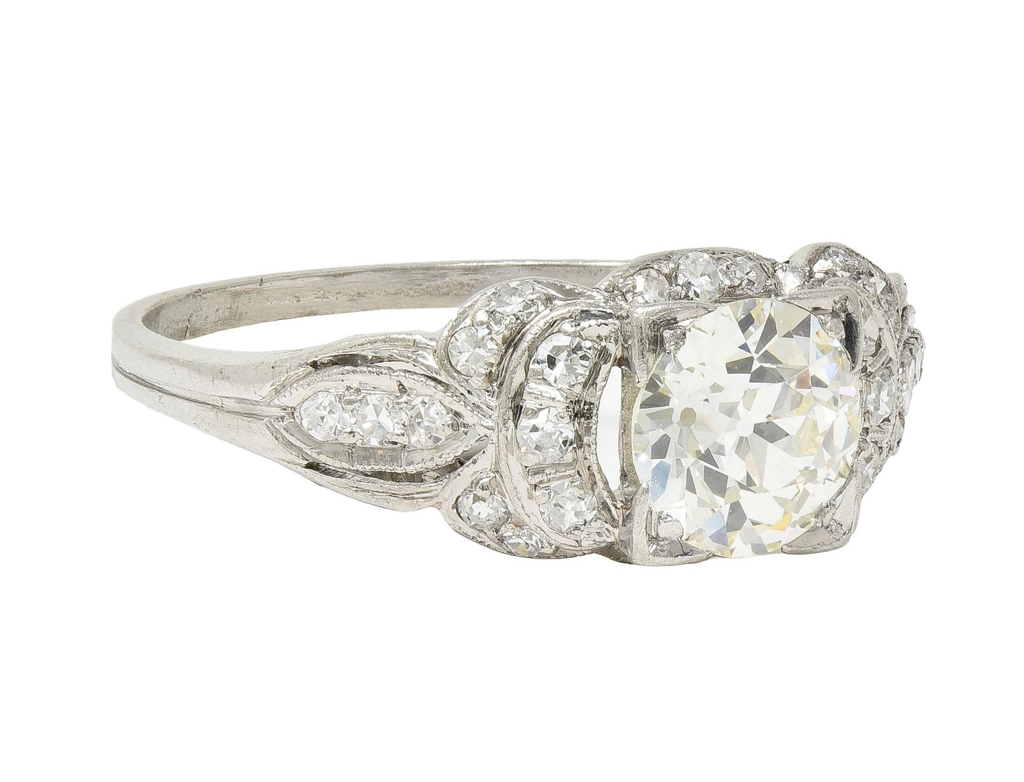 Centering an old European cut diamond weighing approximately 1.16 carats - K color with VS2 clarity
Bead set in a square form head above a tiered and pierced bow motif surround
With single cut diamonds throughout weighing approximately 0.19 carat