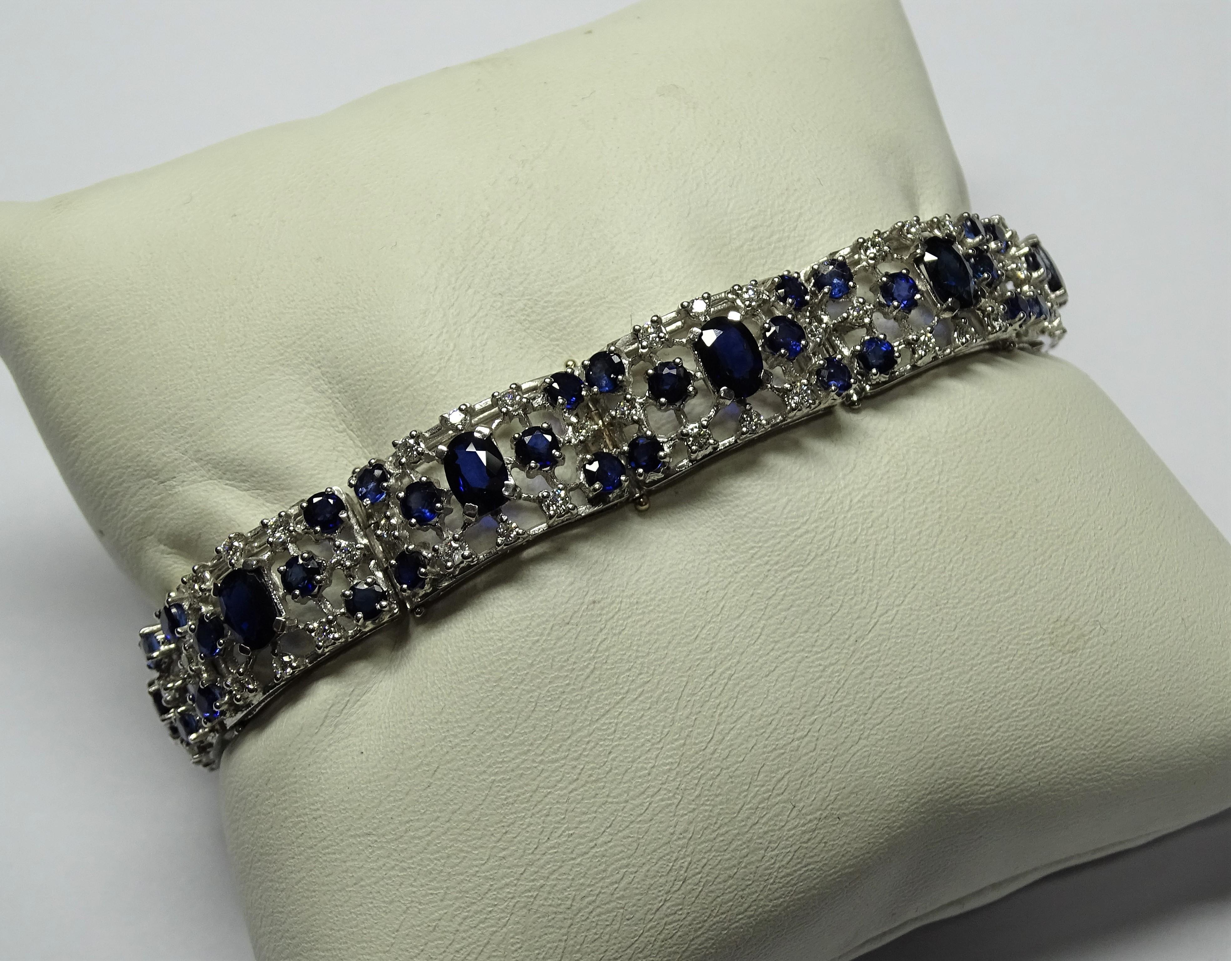 The Bracelet  is made of 18K White Gold.
The Bracelet has 1.76 Carat of White Diamonds Modern Round Cut.
The Bracelet has 13.84 Carats of Oval and Round Sapphires.
This Bracelet is inspired by Art Deco.
We're a workshop so every piece is handmade,
