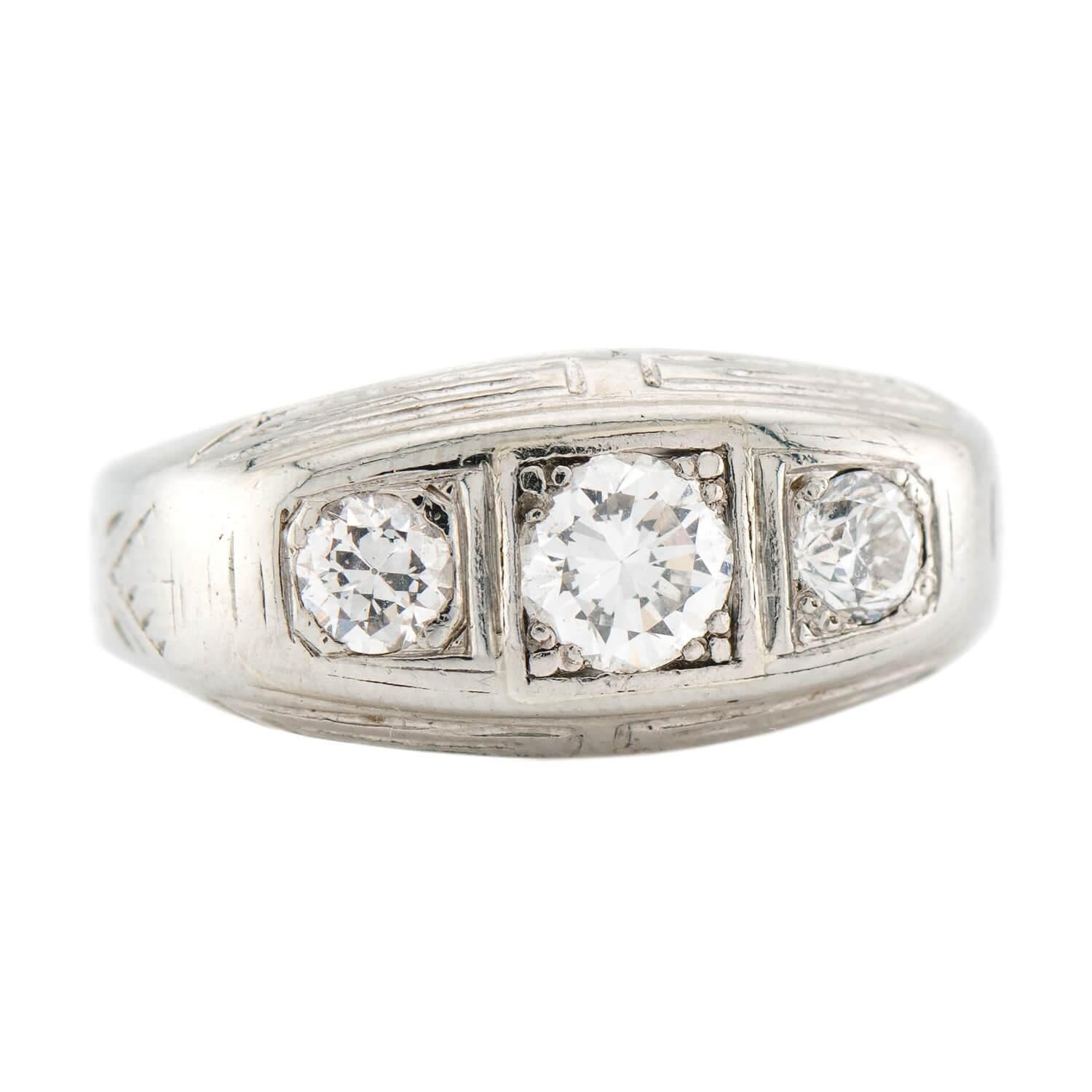 A beautiful flush mount diamond ring from the Victorian (ca1880) era! Crafted in 13k white gold, the front of this ring features three old European cut diamonds, which are held within flush bead-settings and run horizontally across a