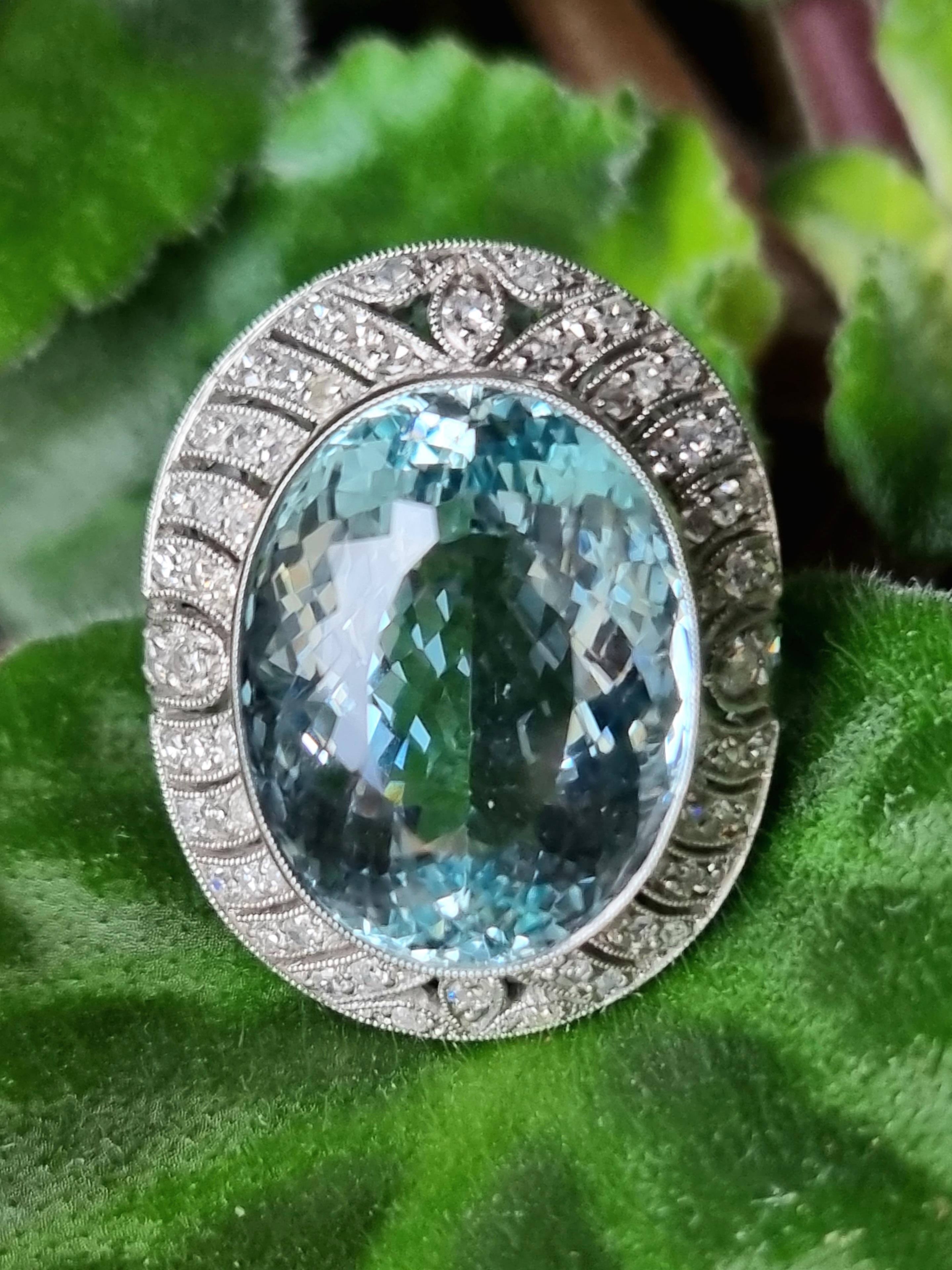 Art-Deco 14 carats Natural Aquamarine and Diamond in Platinum Ring.
Centrally set with an oval  cut Natural Aquamarine (No Treated/ Investment Grade), in an open back claw setting with an approximate weight of 14.40 carats, further set surrounding
