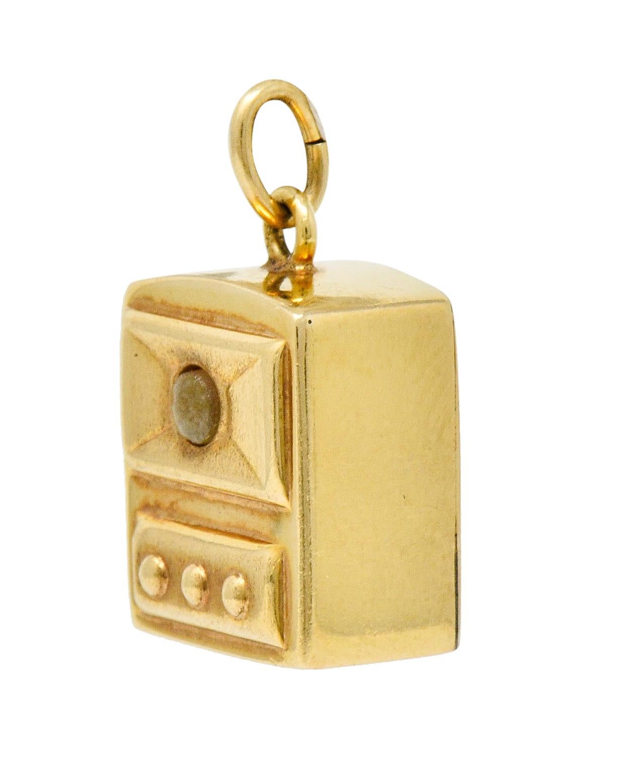 Rectangular form designed as a stylized vintage television

Centering a 2.5 mm round rock crystal cabochon peephole

Viewing through peephole depicts a microphotograph of popular New York icons; 

Statue of Liberty, Empire State Building, and the
