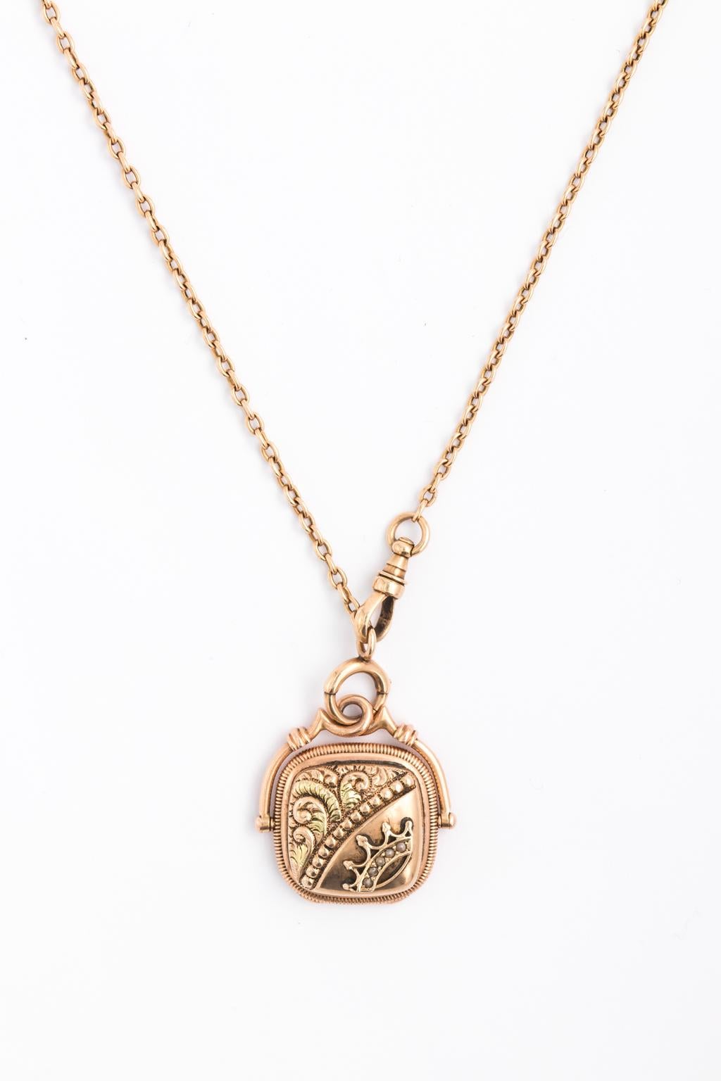 Art Deco curb watch chain in 14kt gold with a photo locket charm with pearl decoration on the front. Locket opening on the indentation on the bottom of charm.