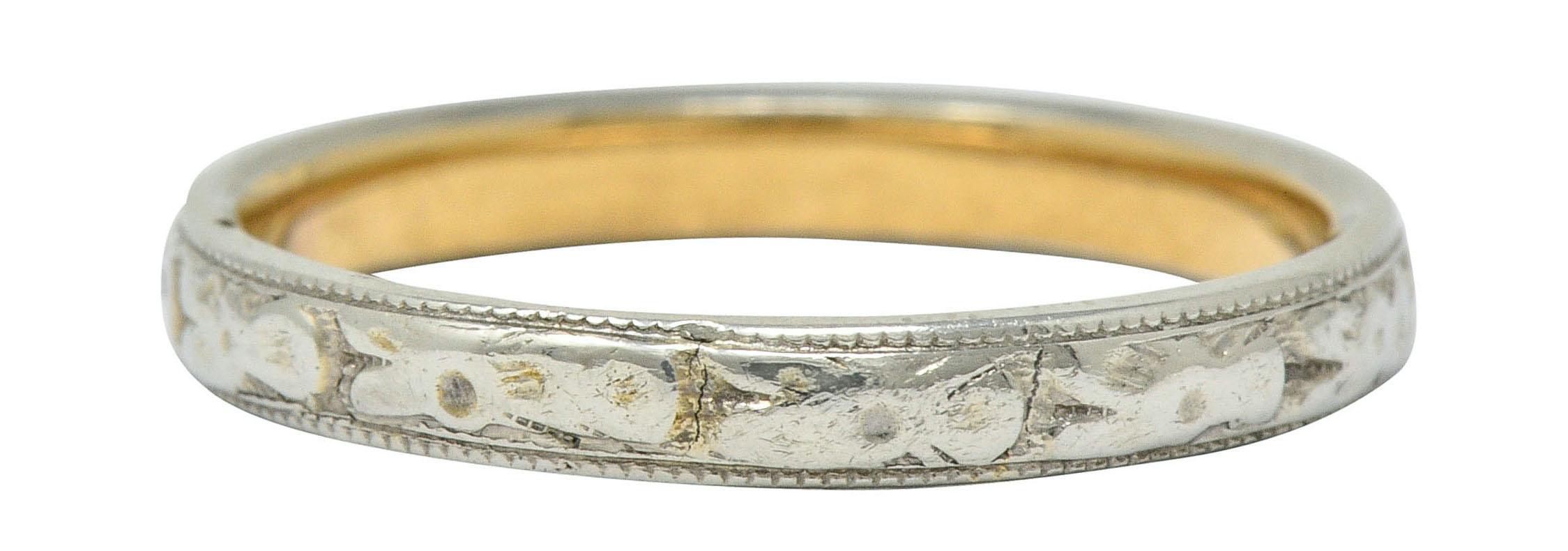 Band ring features highly rendered white gold orange blossom motif and milgrain edges

Inner shank is yellow gold with a dated inscription

Stamped 14K for 14 karat gold

Circa: 1920s

Ring Size: 8 & not sizable

Measures: 2.9 mm wide and sits 1.7