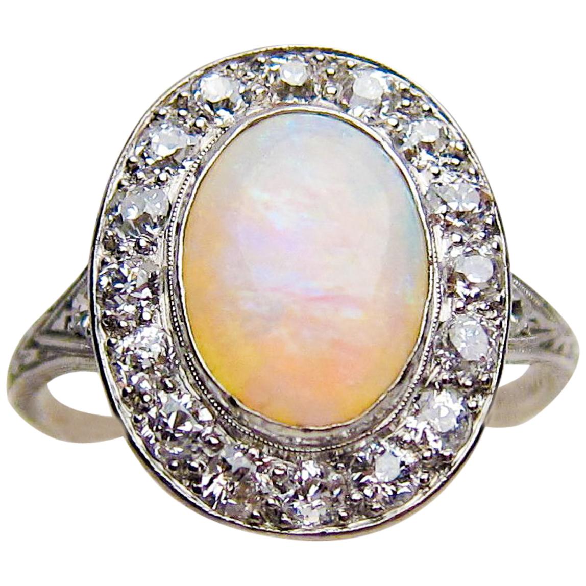 Art Deco 1.40 Carat Cabochon-Cut Opal and Diamond Halo Platinum Ring For Sale