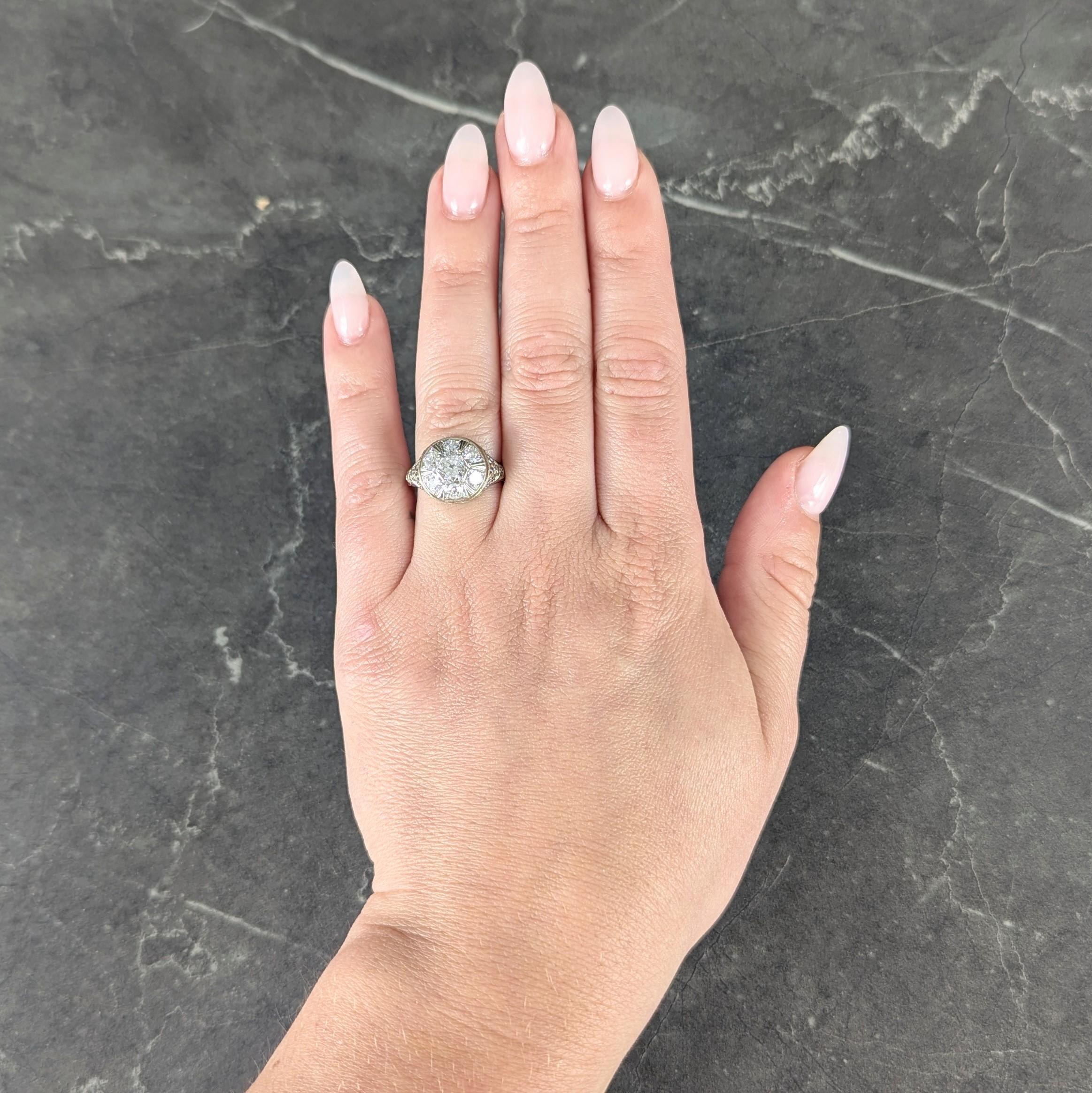 Centering an old European cut diamond weighing approximately 0.44 carat - H color with SI1 clarity
Bead set and featuring a clustered surround of additional bead set old European cut diamonds
Weighing approximately 0.96 carat total - H color with