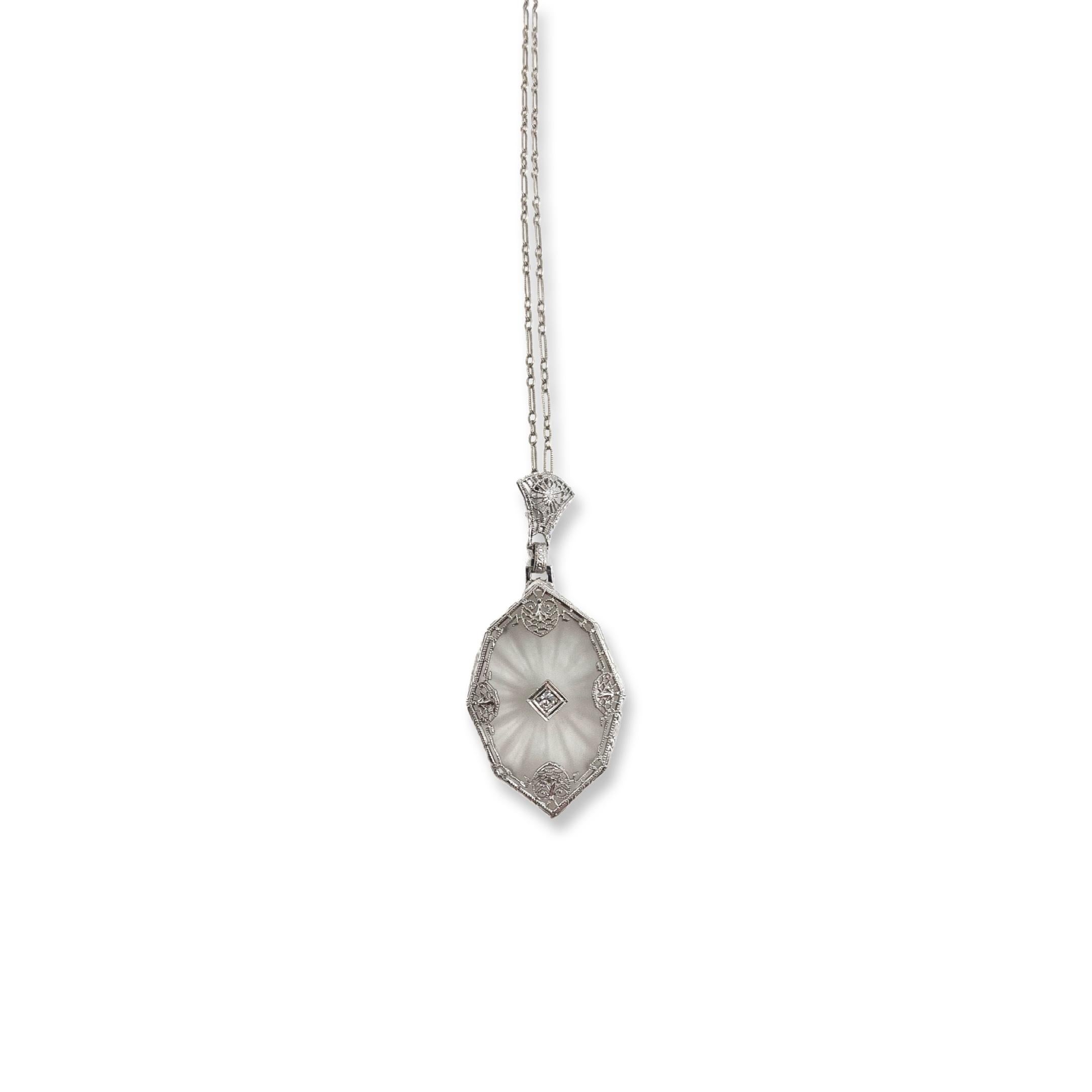This beautiful antique piece was handcrafted sometime during the Art Deco design period (1920-1940). The pendant is Depression Era and crafted from 10K white gold. The chain is modern made and is 14K white gold. The pendant features a large camphor