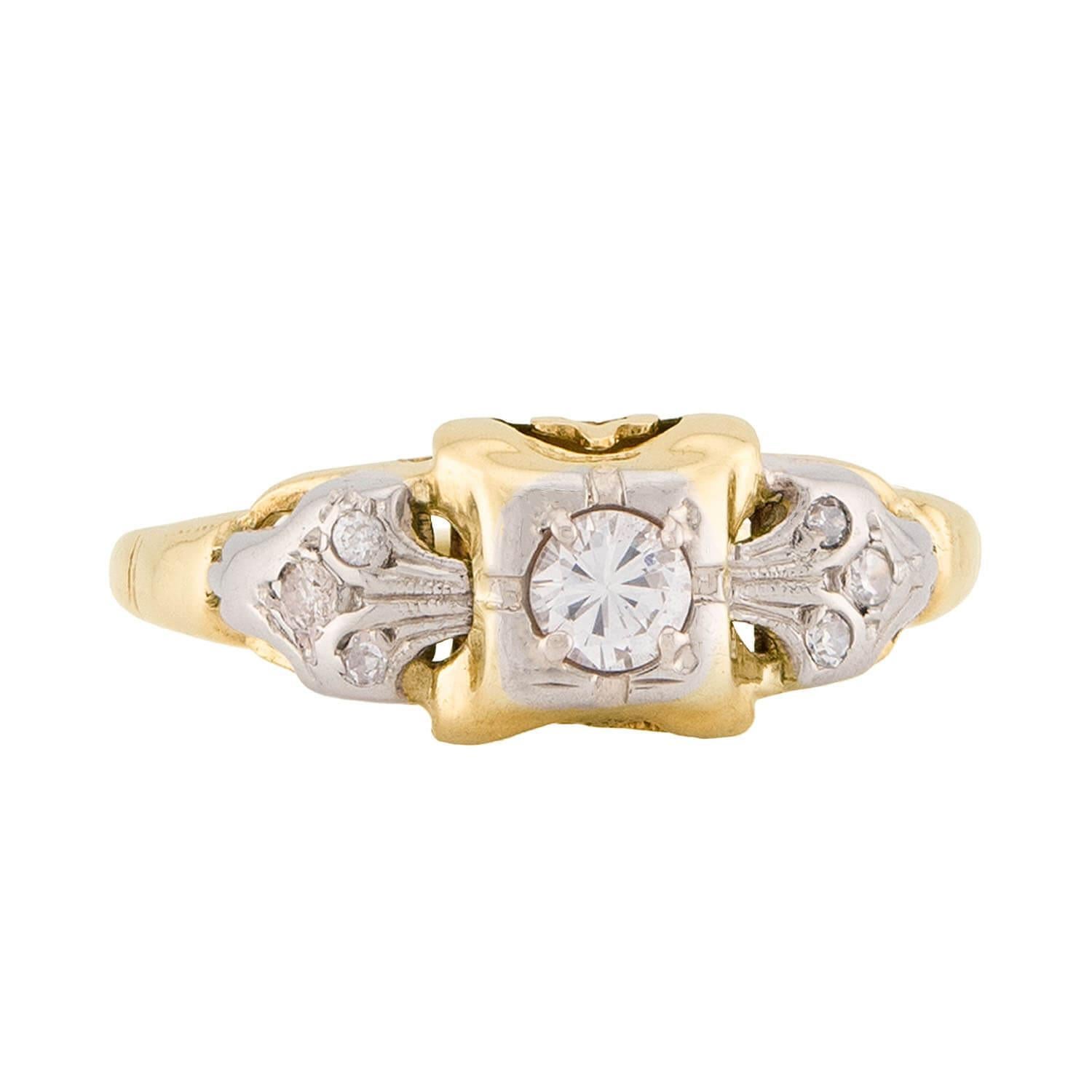 An absolutely beautiful diamond engagement ring from the Art Deco (ca1920s) era! This lovely ring is crafted in 14k yellow gold and white gold, and features a central .15ct old European cut diamond. The stone is held within a four-prong setting, and