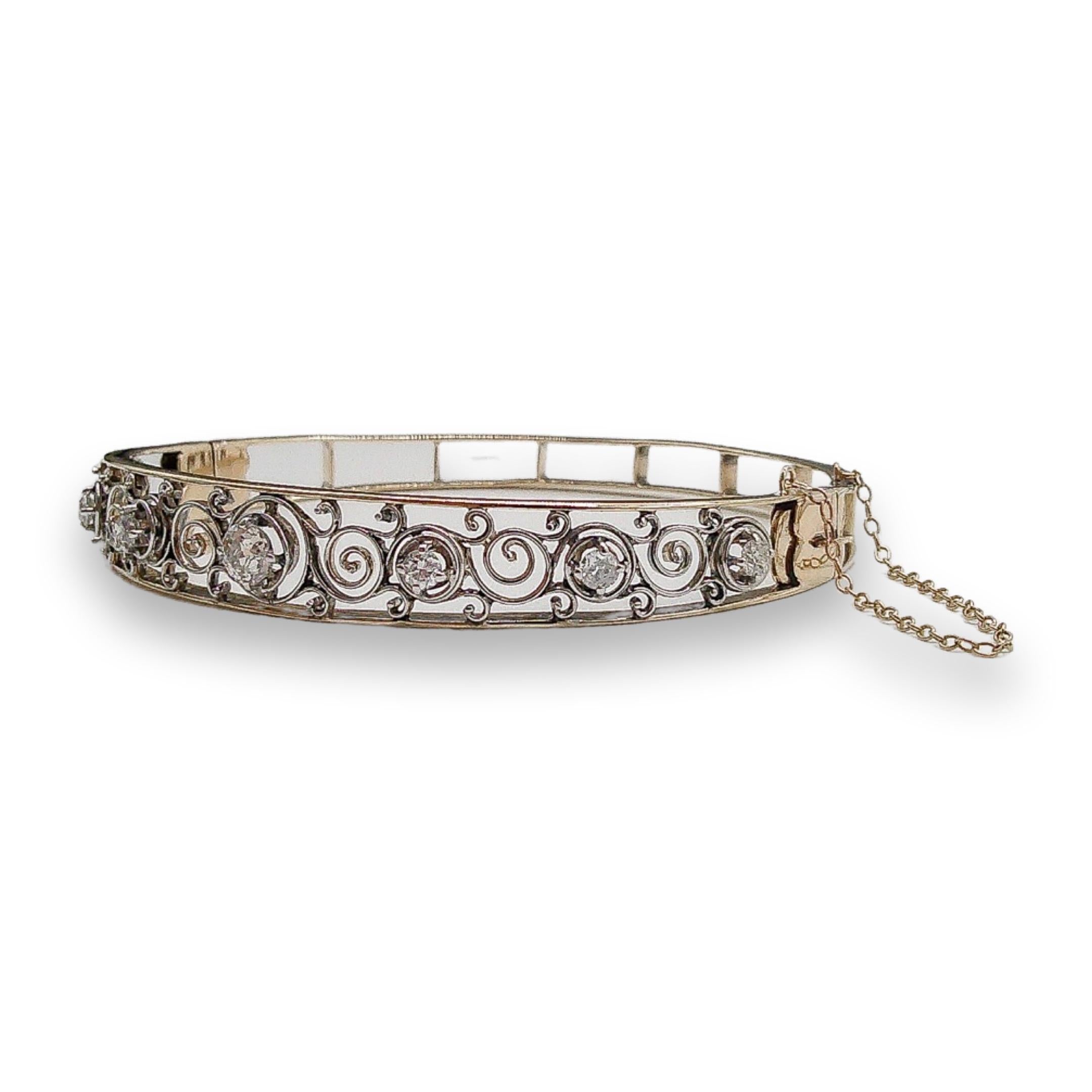 This stunning antique bangle was handcrafted sometime during the Art Deco design period (1920-1940). Crafted with utmost precision, this enchanting bangle combines the richness of 14k gold with a harmonious blend of white and yellow tones, creating