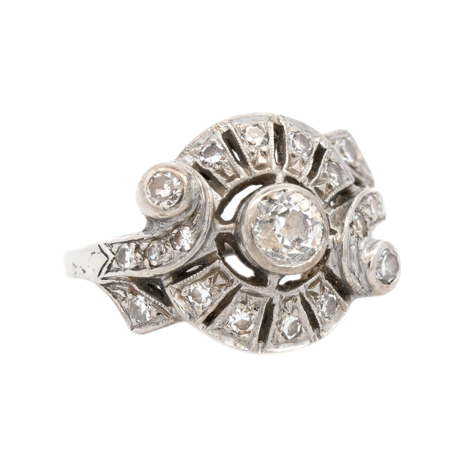 A truly exceptional diamond ring from the Art Deco (ca1920) era! This incredible ring is crafted in 14k white gold, and features a central old mine cut diamond, held within a bezel setting. The central stone has an approximate total carat weight of
