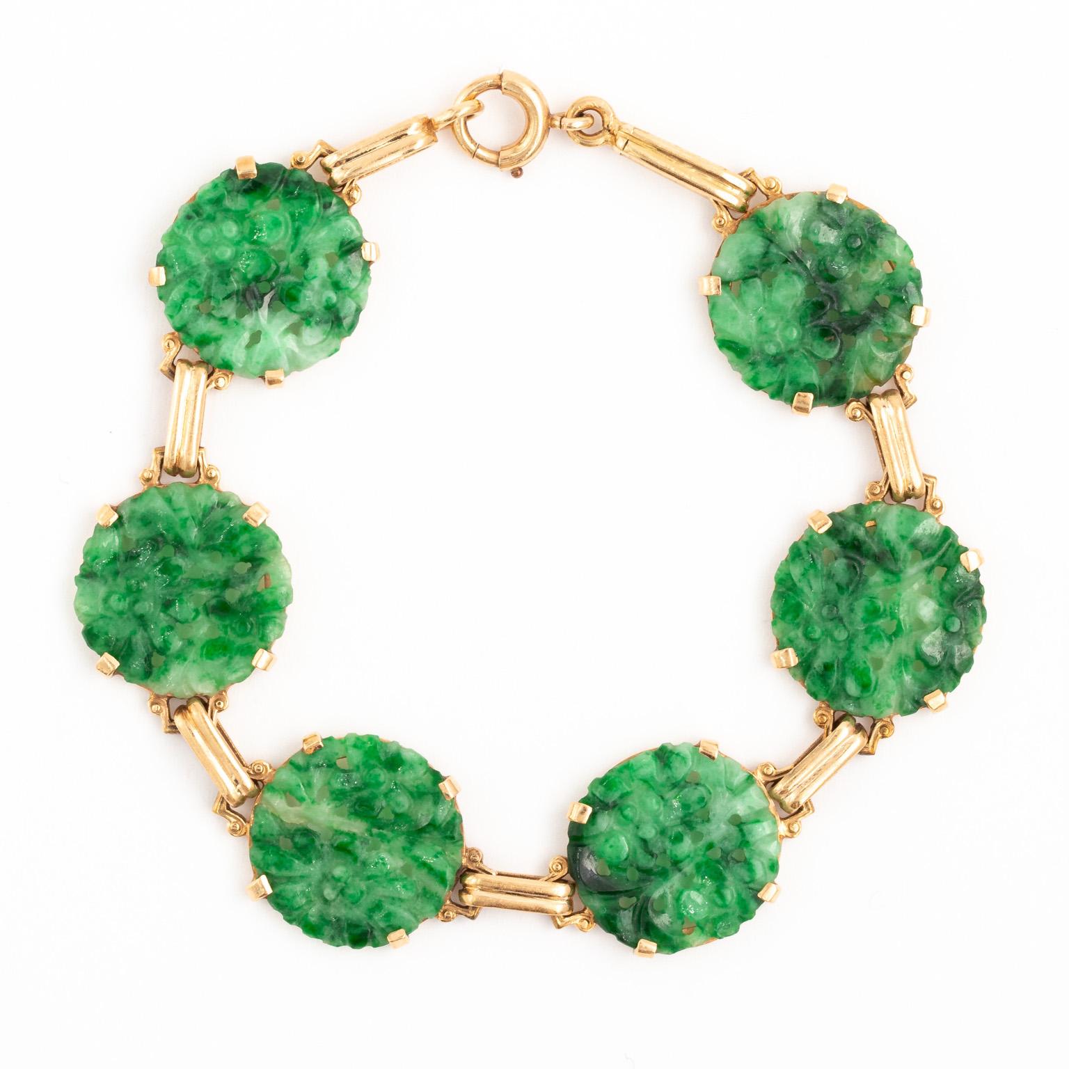 Lovely bracelet made around 1930s. It is constructed in solid 14k Yellow Gold. There are a total of 6 round disks each 15mm, thinly carved and originally probably used for buttons or ornaments on clothing in the 19th century. Each is a deep emerald