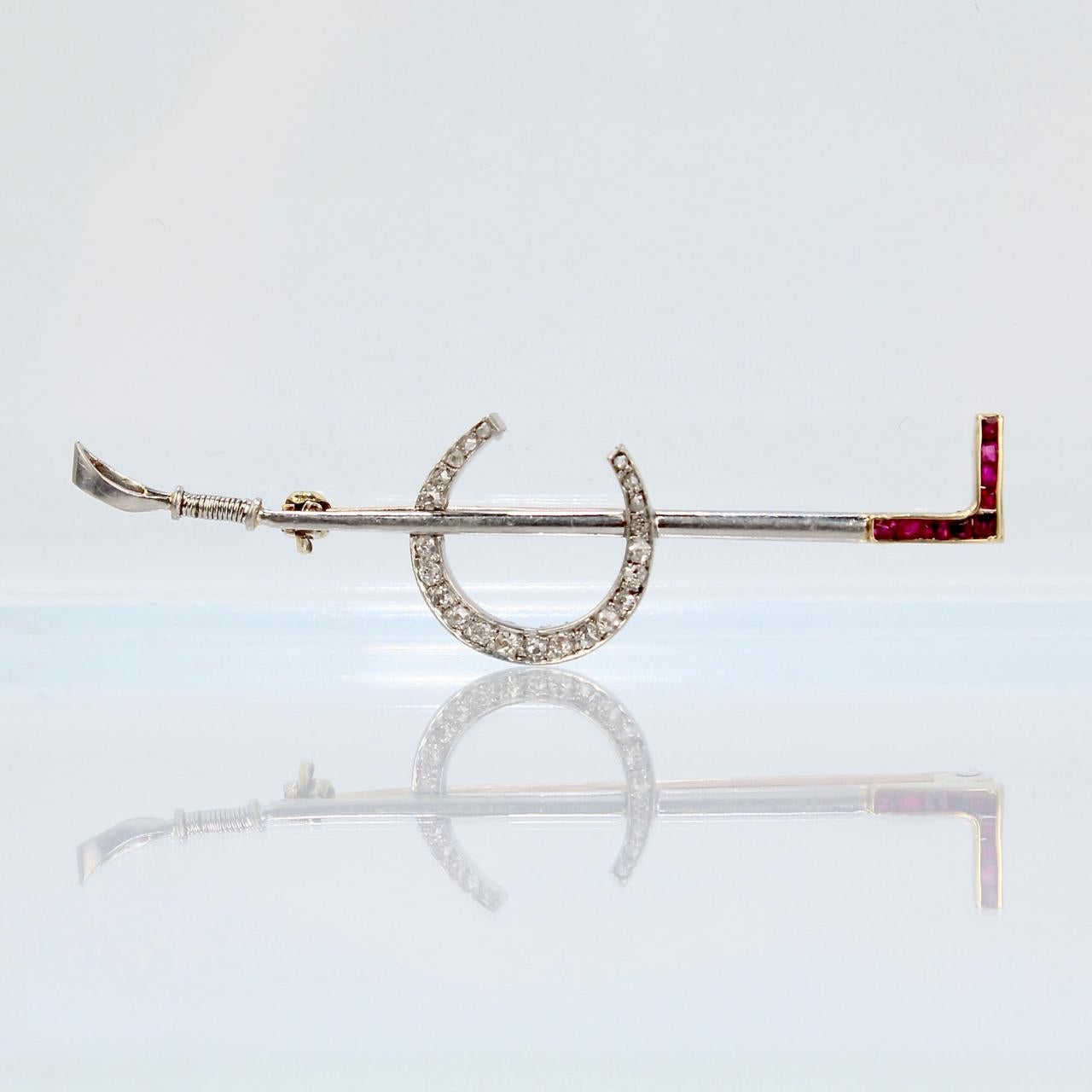 A very fine Art Deco riding crop and horse shoe pin or brooch.

In platinum-topped 14K gold with 16 small diamonds and 6 small baguette rubies.

Marked to the reverse 14k for gold fineness.

Simply a finely crafted brooch! The perfect gift for those