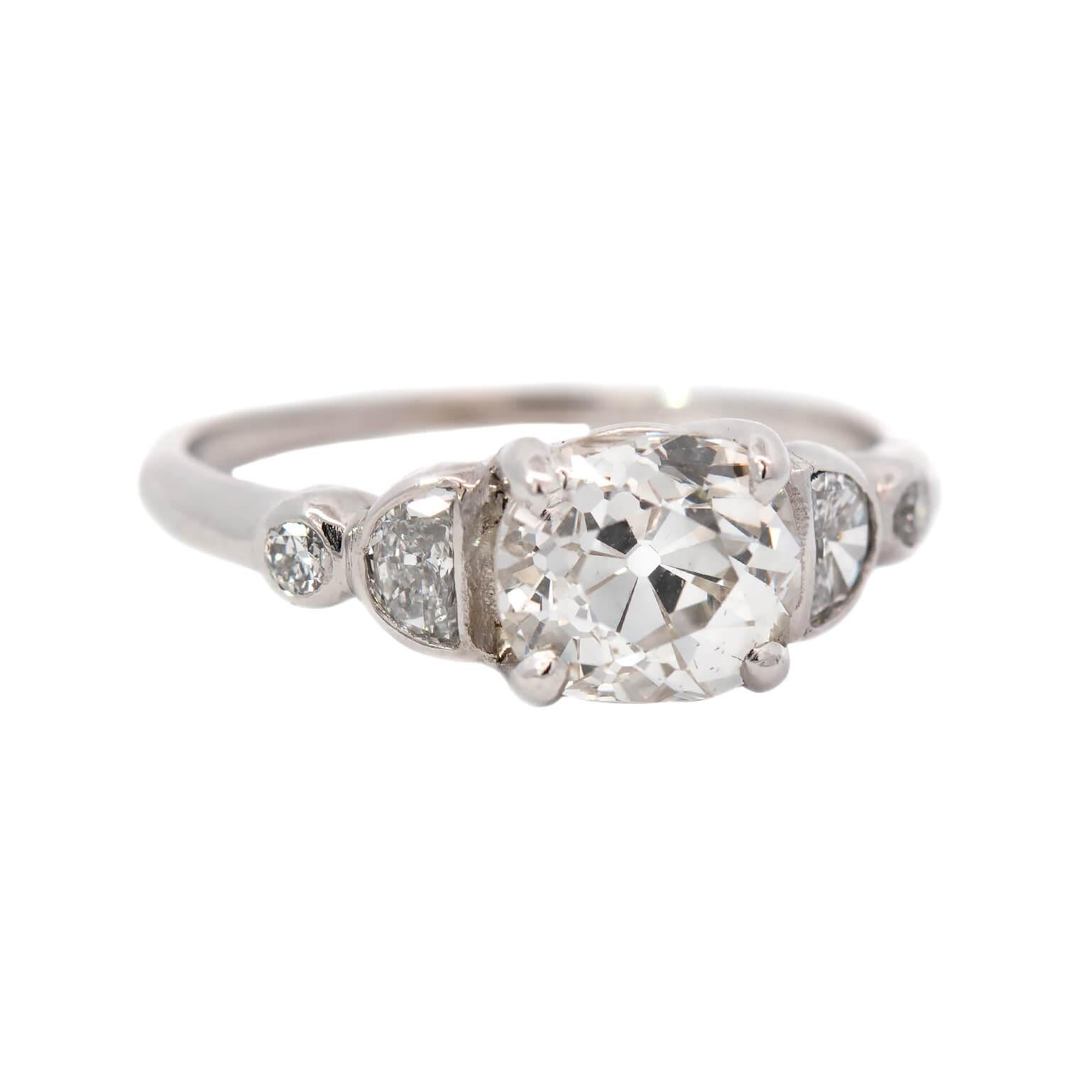 A stunning diamond engagement ring from the Art Deco (ca1920) era! This beautiful ring is made of 14k white gold and features a dazzling old European Cut diamond in the center. The diamond, which is prong set, is resting in a simple basket-style