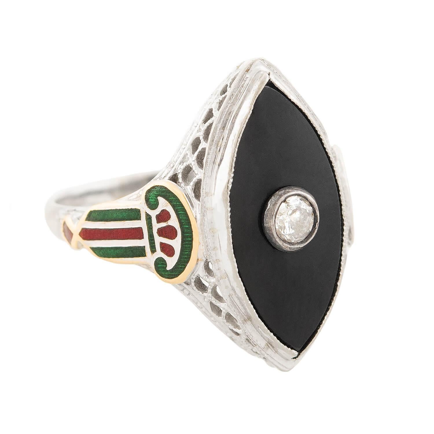 A fabulous onyx and diamond ring from the Art Deco (ca1920s) era! Crafted in 14k white gold, this striking piece features a navette-style onyx centerpiece. The onyx stone is held within a smooth and simple bezel setting, and displays a lovely dark