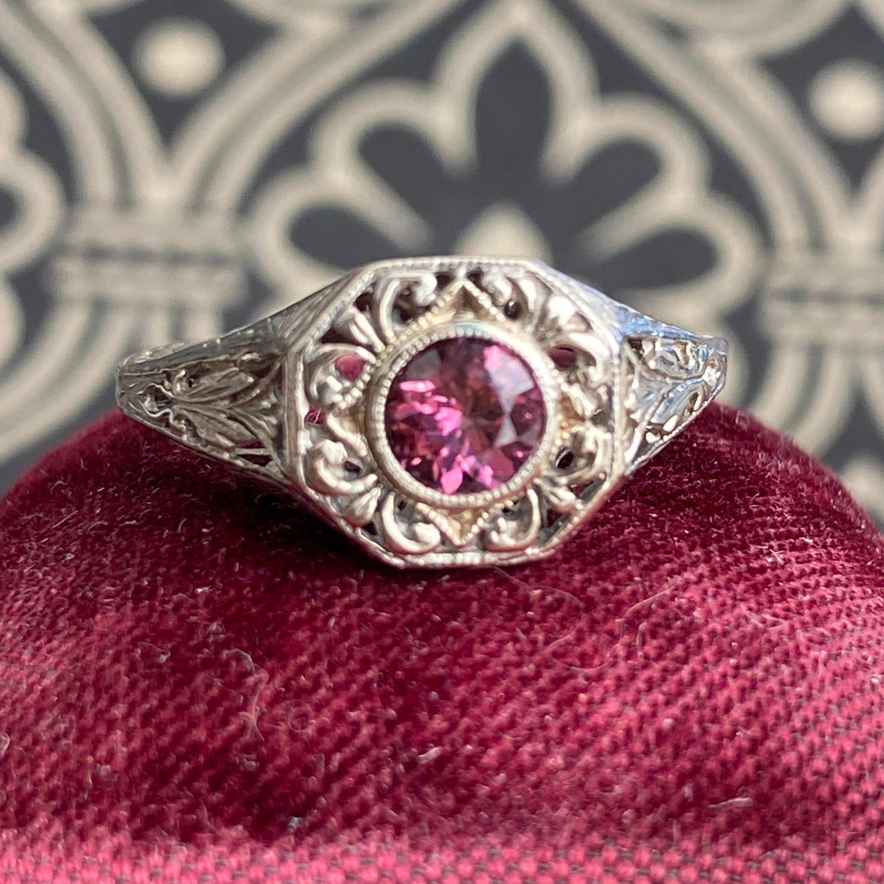 Details:
Stunning Art Deco Period Tourmaline and 14K white gold ring—would make a lovely engagement ring! The center stone is estimated .30 carats, and measures 4.6mm round. The filigree is beautiful on this ring, and is in lovely shape. This is a