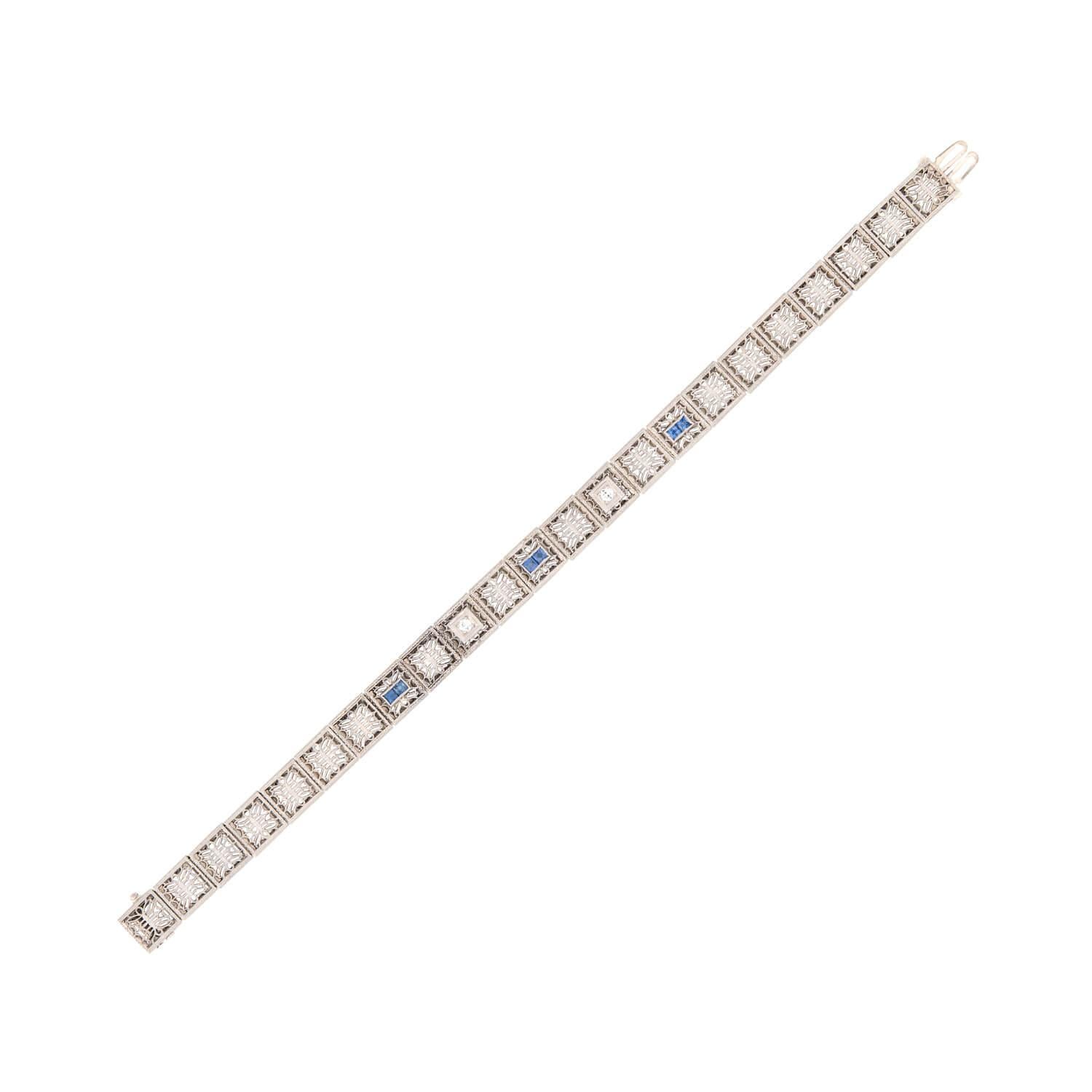 A gorgeous line bracelet from the Art Deco (ca1920) era! Crafted in 14k and topped in platinum, this stunning piece is comprised of 23 box links that have a beautiful filigree wirework design. Two of the links are detailed with old European cut