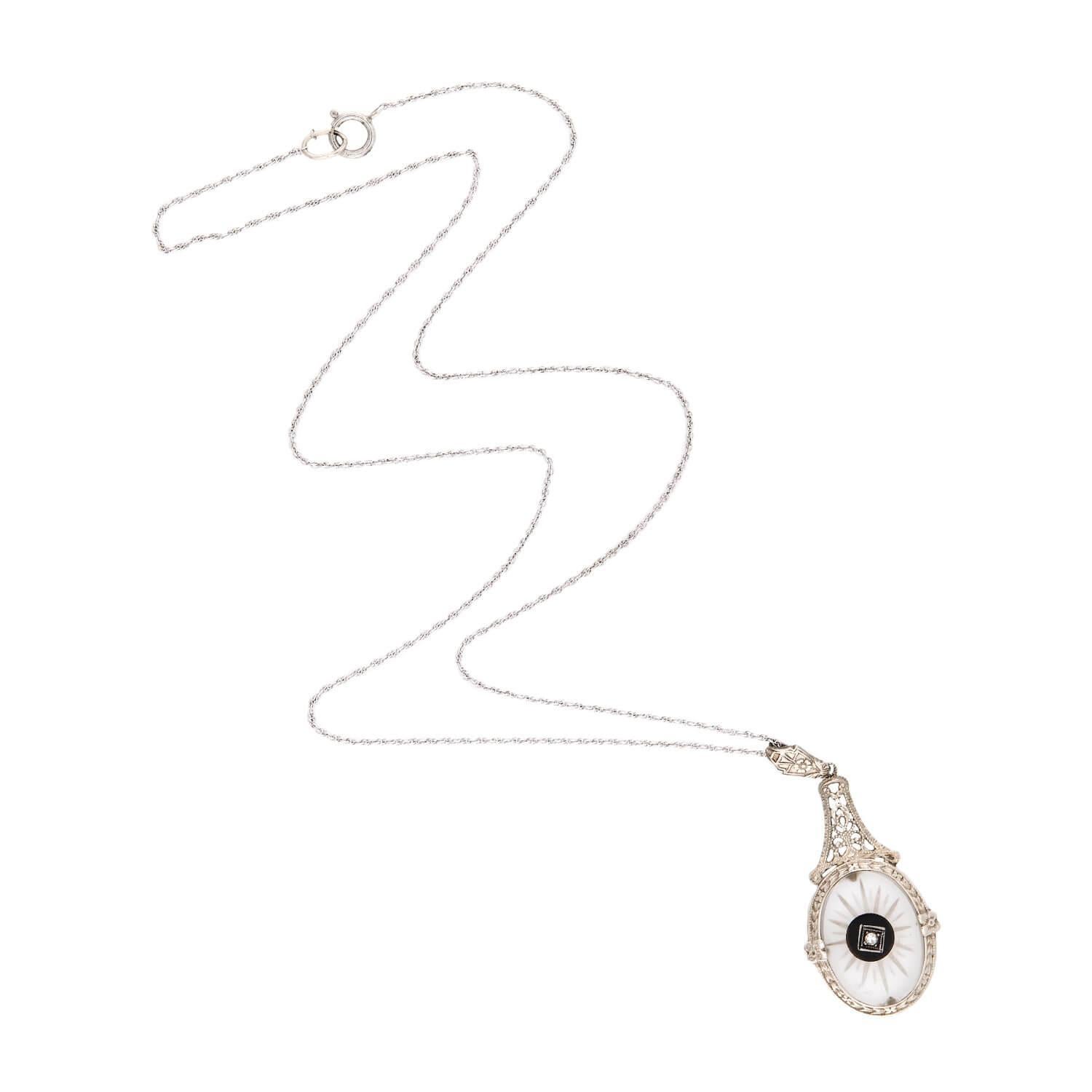A beautiful pendant necklace from the Art Deco (ca1920s) era! Crafted in 14k white gold, this necklace is comprised of a dainty rope chain, which secures with a simple spring ring clasp which is stamped 
