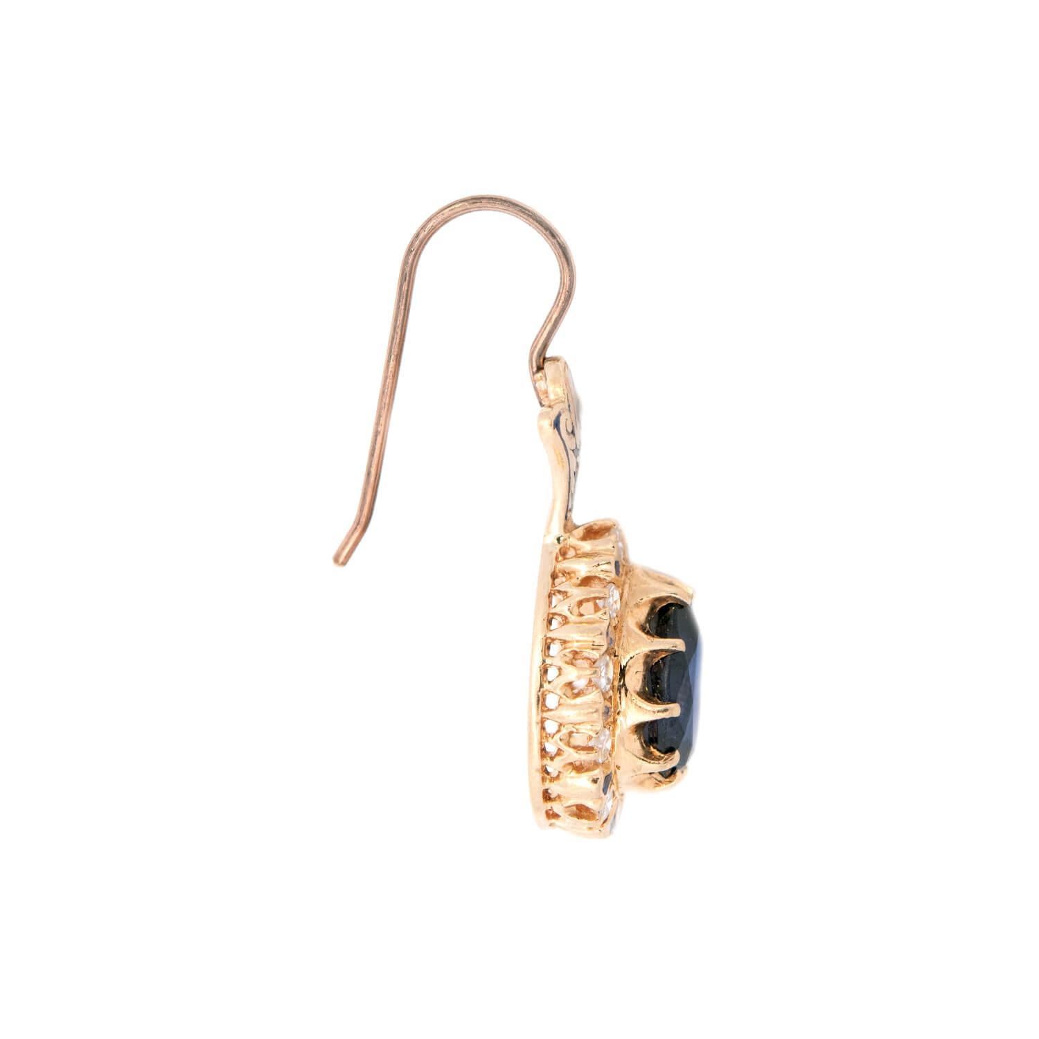 A breathtaking pair of sapphire and diamond earrings from the Art Deco (ca1930s) era! These exquisite earrings are crafted in 14k yellow gold and have an elegant, feminine design. Each earring features a generously sized pear cut sapphire that is