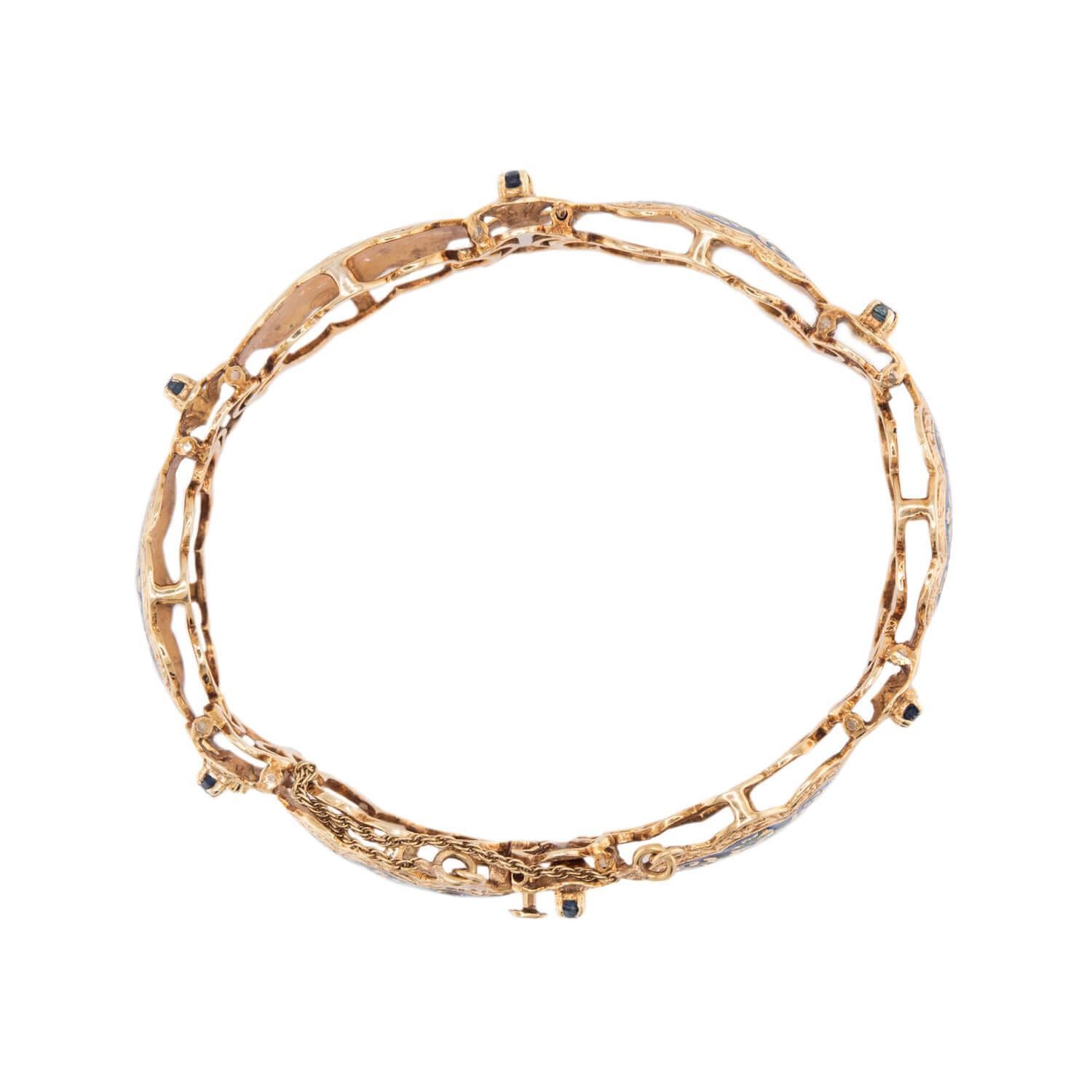 An absolutely breathtaking link bracelet from the Art Deco (ca1930s) era! Crafted in vibrant 14k yellow gold, this bracelet is comprised of 6 cloud-shaped links, which are decorated with colorful enameling. The enameling, which incorporates deep